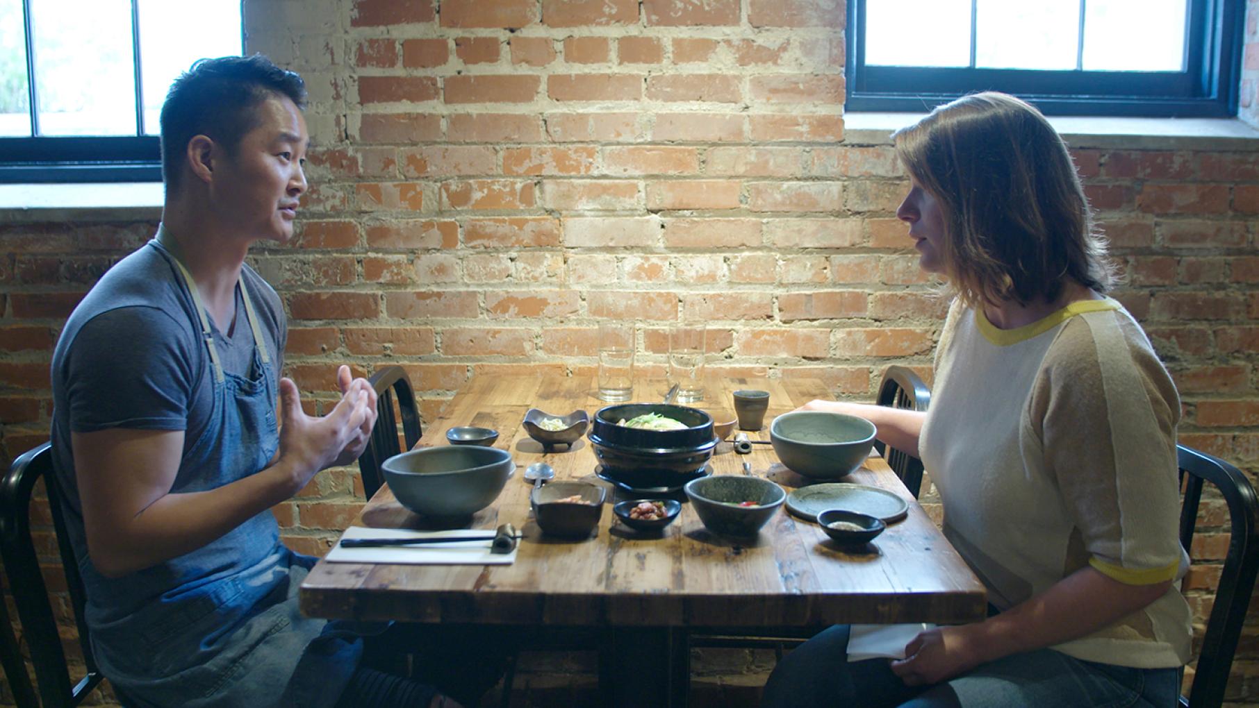 Chef Mike Lee eats Korean samgyetang and banchan with Chef Vivian Howard at his restaurant M Sushi in Durham, in 'South by Somewhere.' Photo: Blaire Johnson/Markay Media