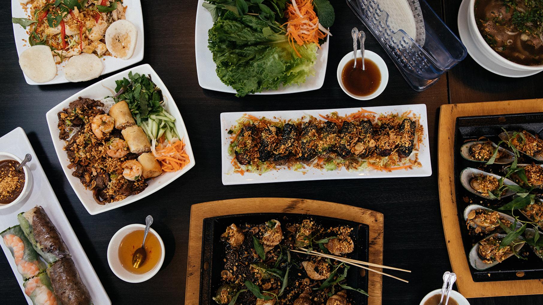 LC Phở n Grill's revamped menu offers a wider variety of dishes. Clockwise from top left: gỏi gà; lettuce and rice paper for bò lá lốt (center); phở đặc biệt chem chép nướng mỡ hành; ốc hương; gỏi cuốn; bún thịt nướng. Photo: Sandy Noto for WTTW Food at Lincoln Square's LC Pho n Grill. Photo: Sandy Noto for WTTW