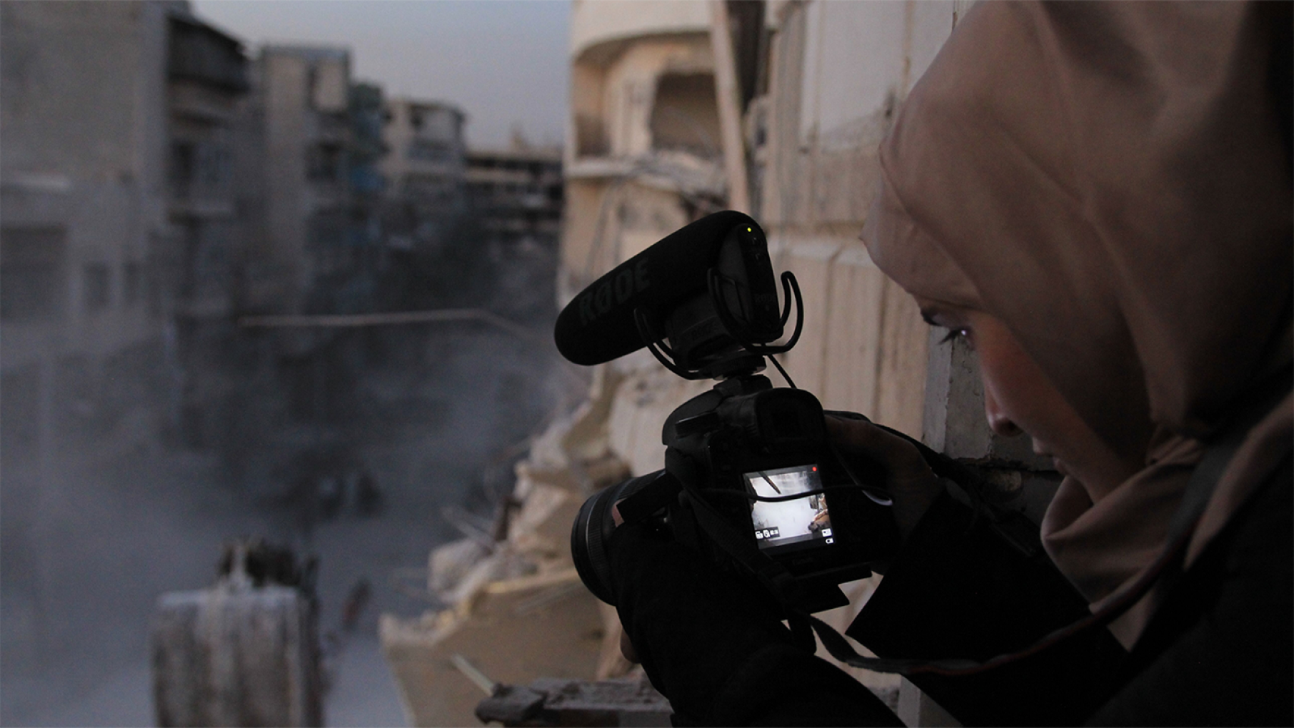 Waad al-Kateab filming the ruins of a building destroyed by bombing in besieged east Aleppo in October 2016. Photo: Waad al-Kateab/FRONTLINE