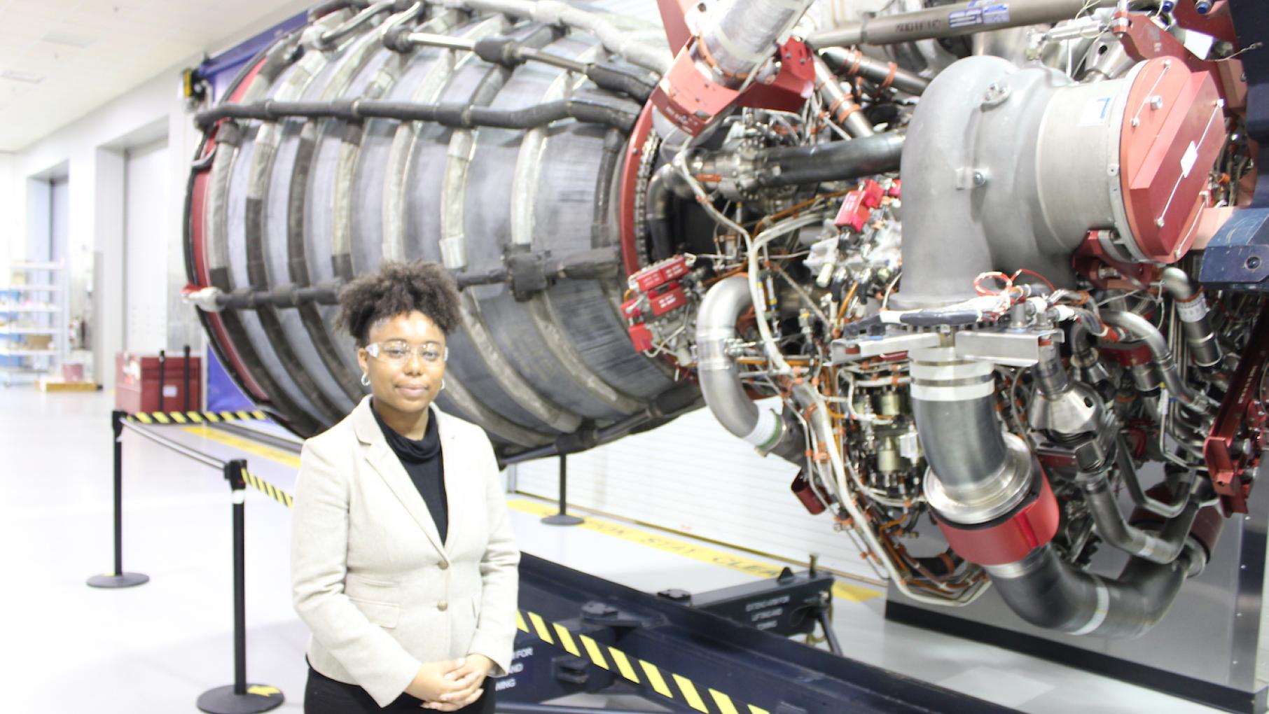 Advocate Tiera Fletcher by a rocket engine at NASA. Photo: Bigger Bang Communications