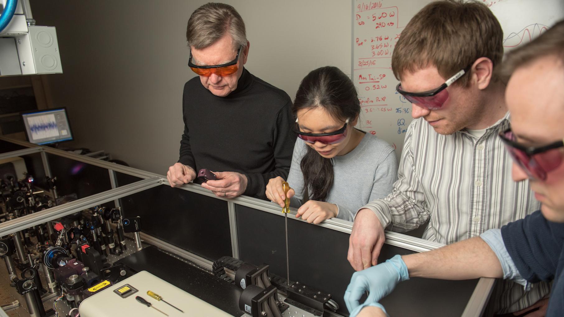 Northwestern Professor Michael R. Wasielewski works with students to tune an ultrafast laser system used for solar energy research. Photo: Institute for Sustainability and Energy at Northwestern University Northwestern Professor Michael R. Wasielewski works with students to tune an ultrafast laser system used for solar energy research. Photo: Institute for Sustainability and Energy at Northwestern University