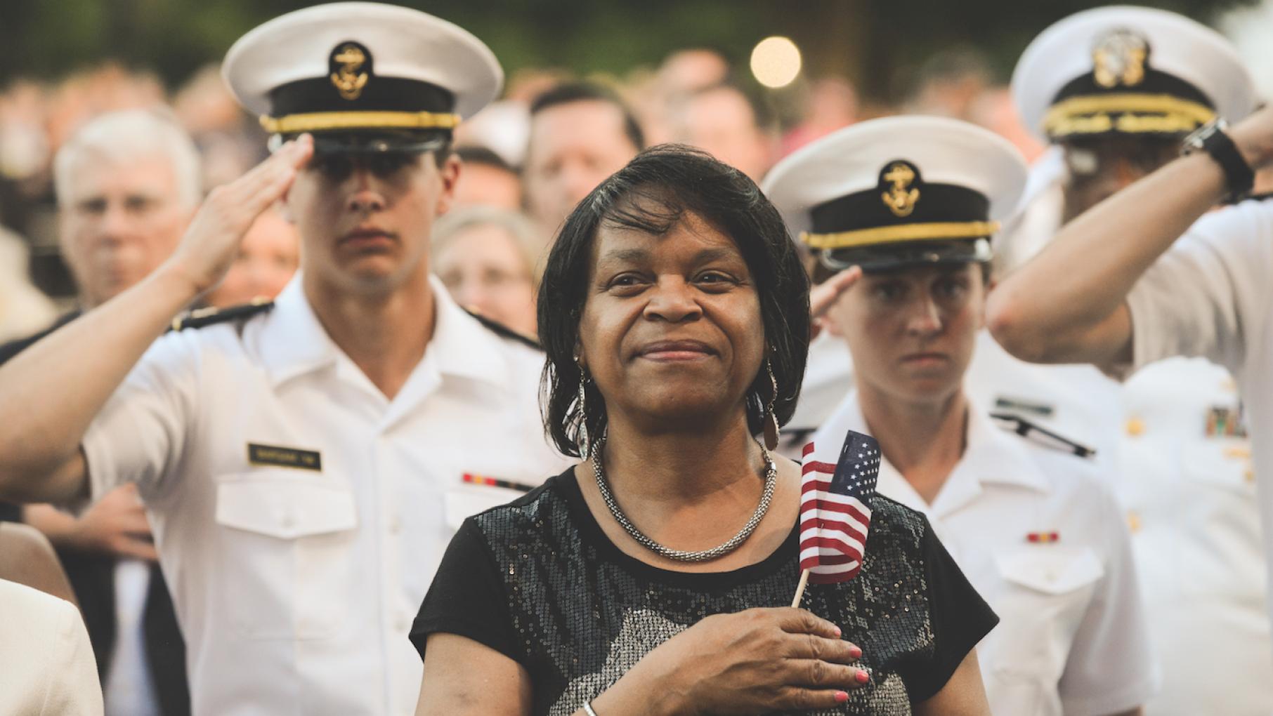 An audience member stands for the national anthem at a previous broadcast of the National Memorial Day Concert. Photo: Capitol Concerts