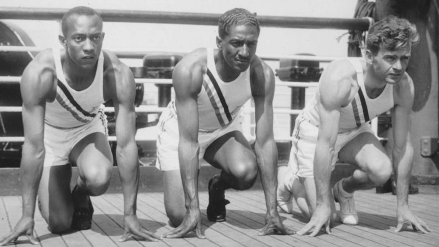 The 1936 U.S. Olympic team sprinters (from left) Jesse Owens, Ralph Metcalfe, and Frank Wykoff on board the S.S. Manhattan before sailing to Germany. Photo: Public domain/Wikimedia Commons Photo of US Olympic team sprinters (from left) Jesse Owens, Ralph Metcalfe and Frank Wykoff on the deck of the S.S. Manhattan before they sailed for Germany to compete in the 1936 Olympics. Photo: Public domain/Wikimedia Commons