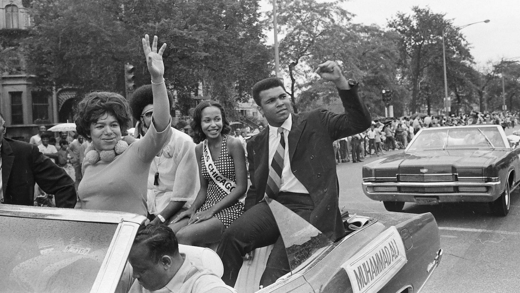 Muhammad Ali sitting in the back of a convertible waving to a crowd during the Bud Billiken Day Parade at 39th Street and Martin Luther King Drive, Chicago, Illinois on August 9, 1969. Photo: ST-40001287-0032, Chicago Sun-Times collection, Chicago History Museum Muhammad Ali sitting in the back of a convertible waving to a crowd during the Bud Billiken Day Parade at 39th Street and Martin Luther King Drive, Chicago, Illinois on August 9, 1969. Photo: ST-40001287-0032, Chicago Sun-Times collection, Chicago History Museum