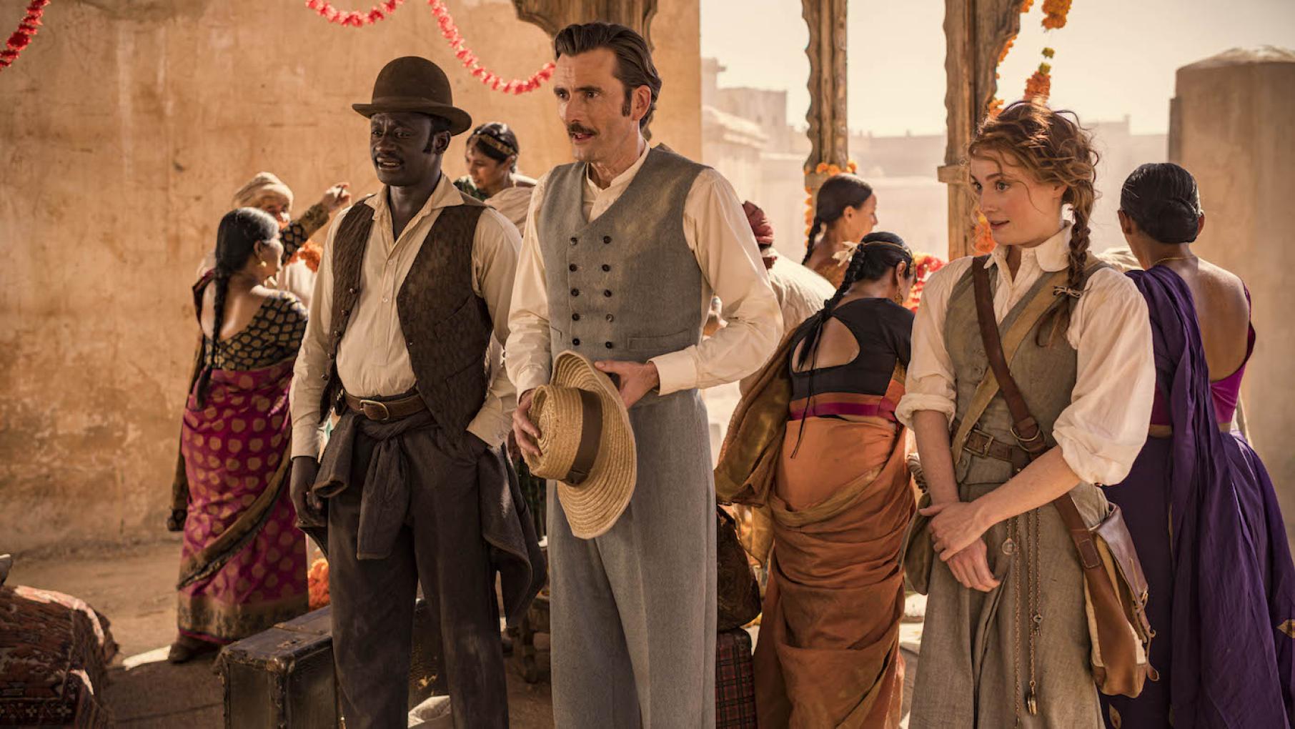 Fogg and his companions end up in an Indian village during a wedding. Photo: Joe Alblas - © Slim 80 Days / Federation Entertainment / Peu Communications / ZDF / Be-Films / RTBF Passepartout, Fogg, and Fix in India in 'Around the World in 80 Days.' Photo: Joe Alblas - © Slim 80 Days / Federation Entertainment / Peu Communications / ZDF / Be-Films / RTBF