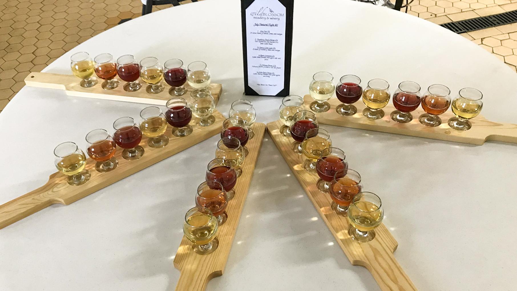 Rows of glasses full of mead at Wild Blossom Meadery and Winery.