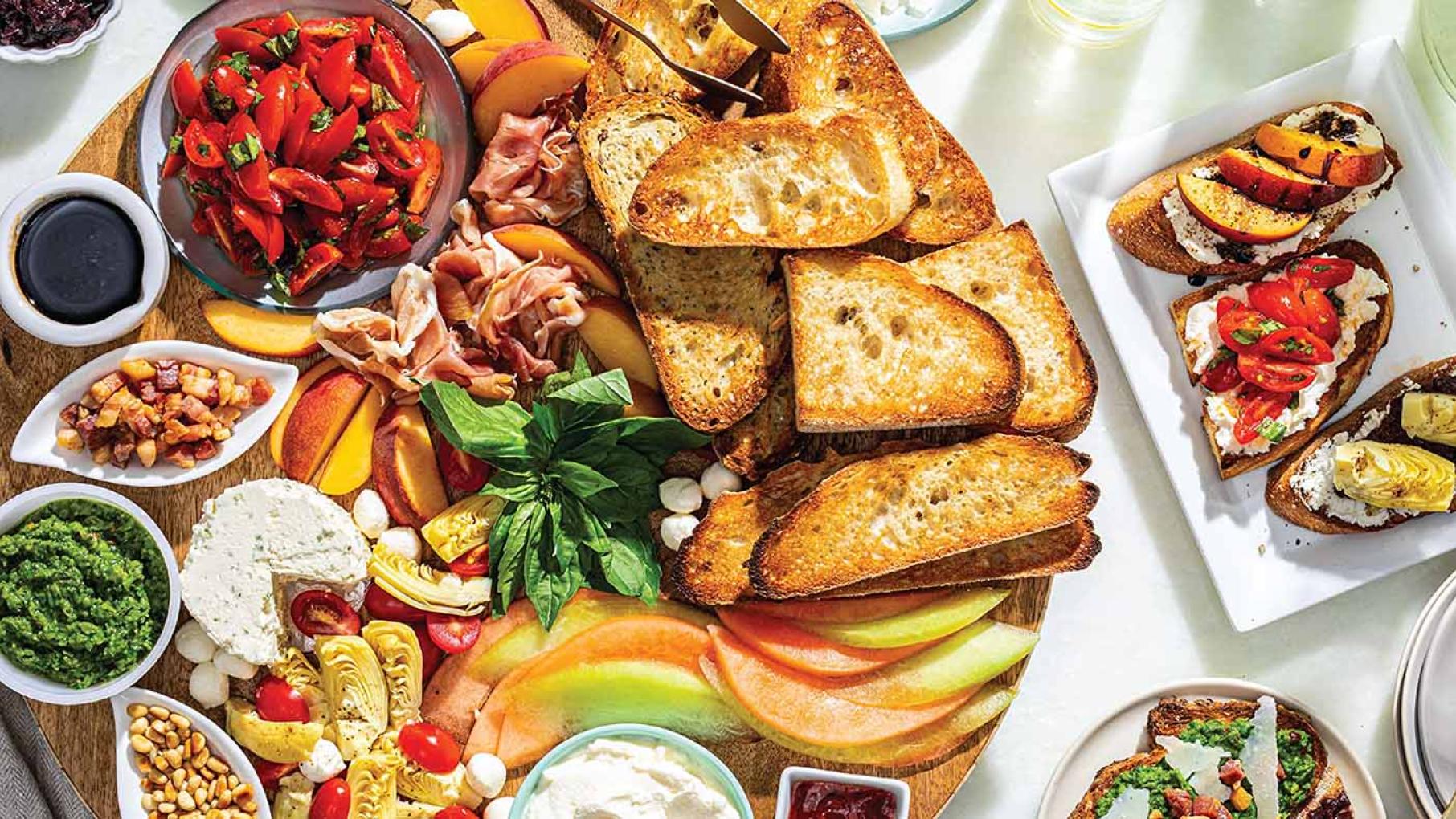 The Bruschetta Board is one of several snack-themed boards in a new cookbook from America's Test Kitchen. Photo: Courtesy of Boards: Stylish Spreads for Casual Gatherings / America's Test Kitchen Bread, vegetables, cheeses, and spreads on a plate.