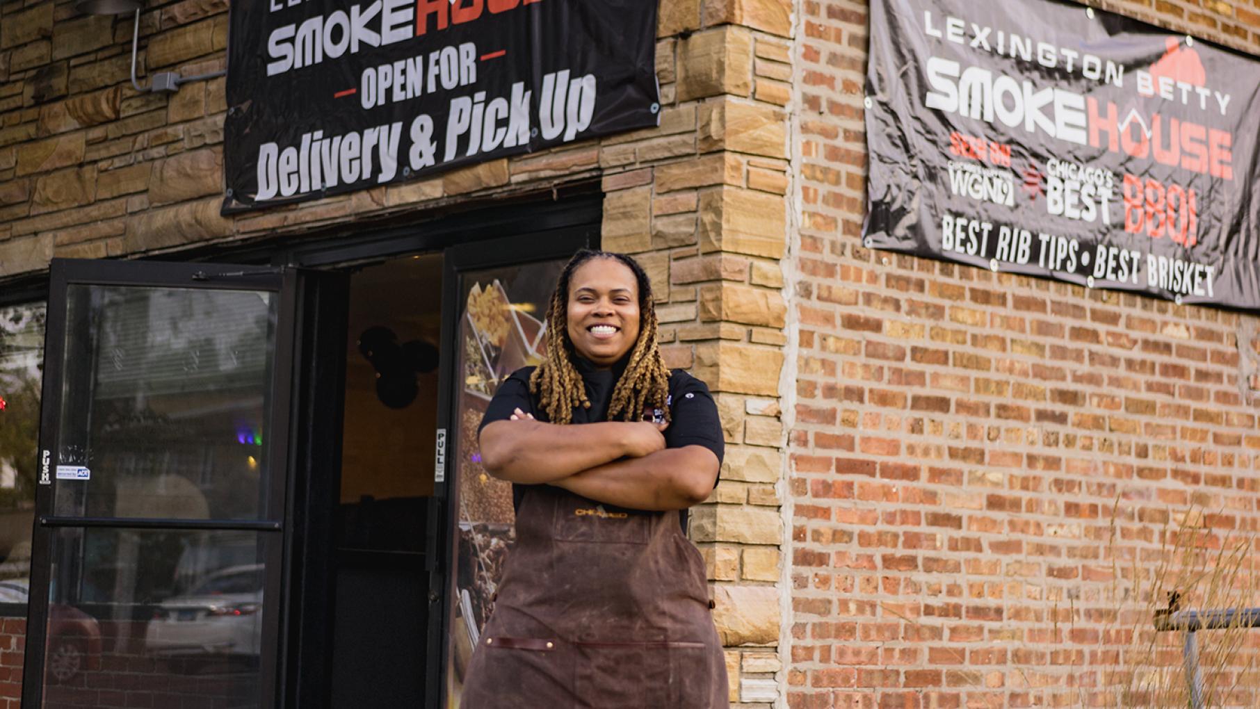 Dominique Leach now has her own line of Wagyu beef steak dogs, but it's been a long journey for the Pullman pitmaster. Image: Provided Pitmaster Dominque Leach in front of Lexington Betty Smoke House