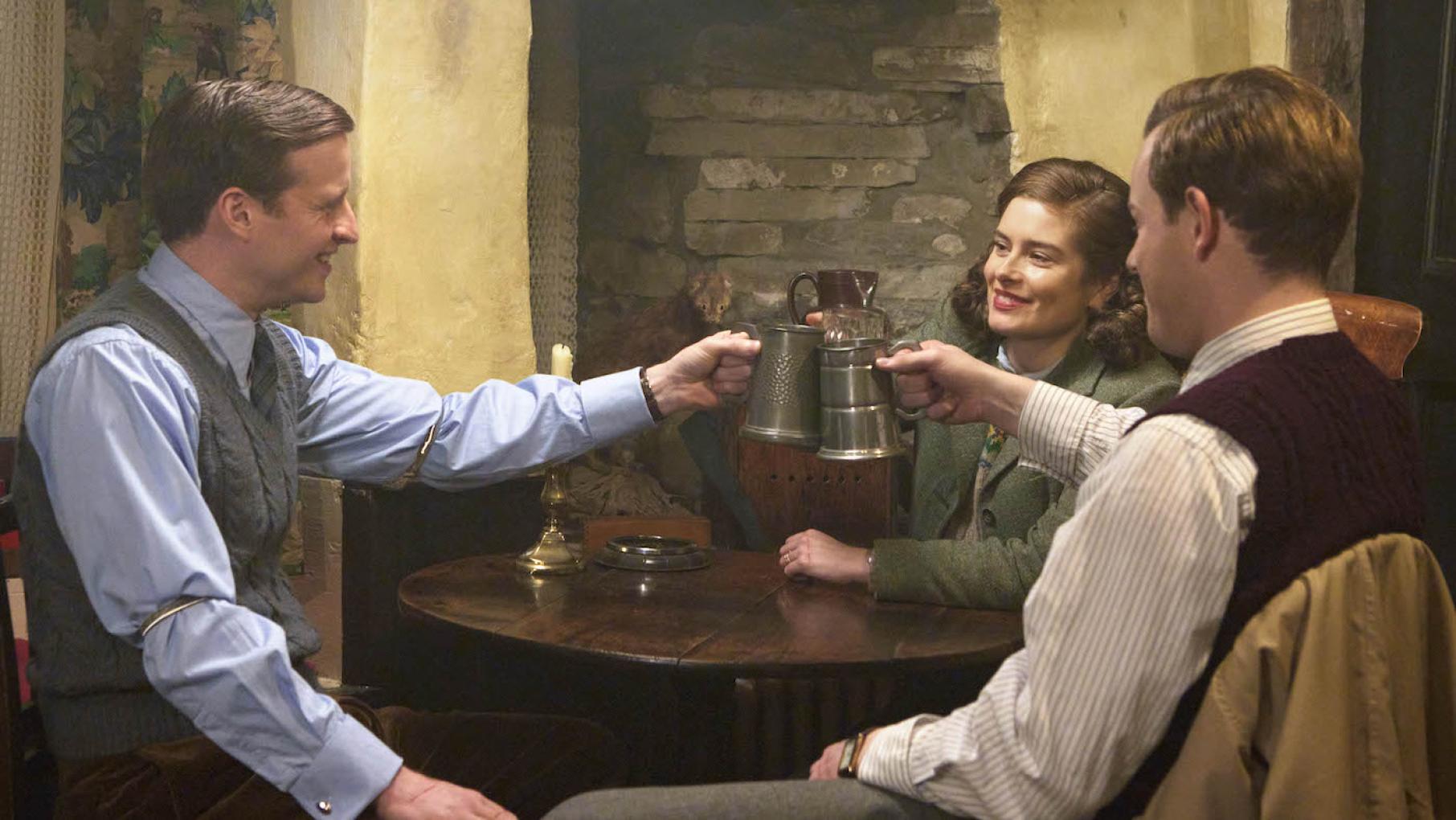 James, Helen, and Tristan agree to present a united front against the "combustible" Siegfried. Photo: Playground Entertainment and Masterpiece James, Helen, and Tristan at the pub together in All Creatures Great and Small