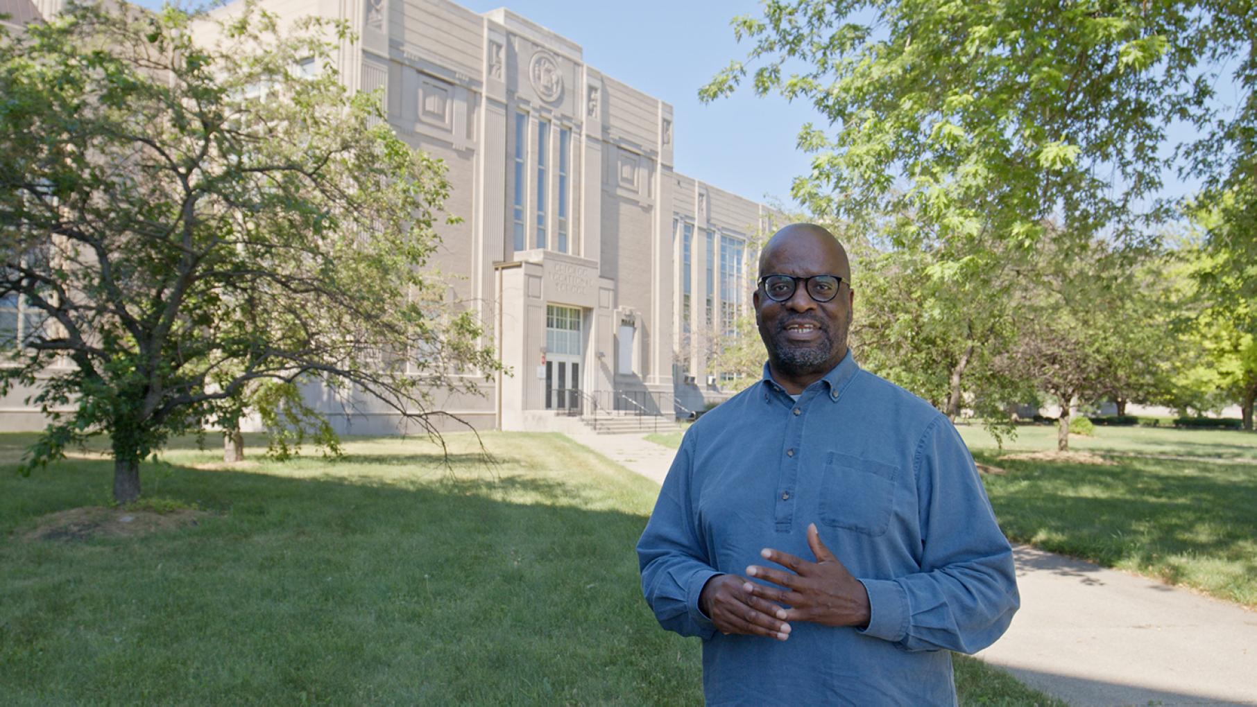 Chicago Vocational High School “is just a tour de force of size and beauty and detail,” says Lee Bey, the host of the new 'Building/Blocks: Architecture of Chicago's South Side.' Image: Provided Lee Bey in front of Chicago Vocational High School