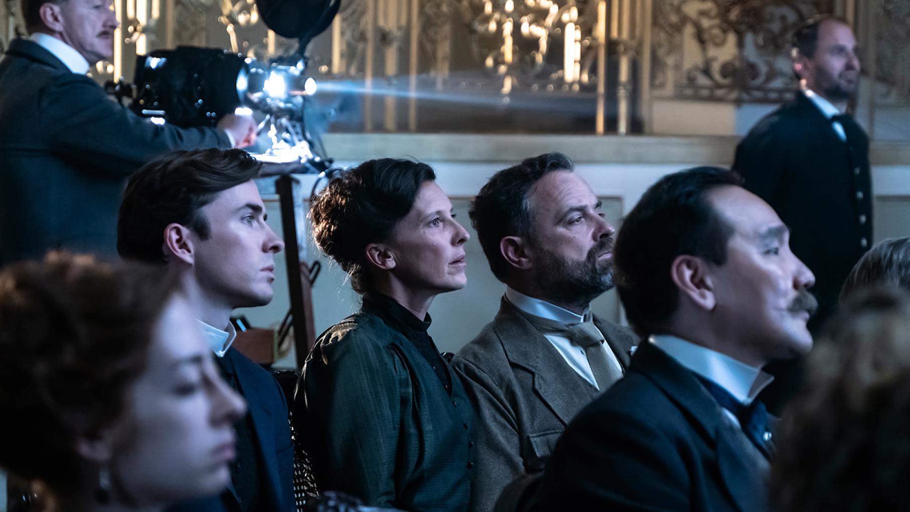 Max, Therese, and Oskar witness a death a film premiere. Photo: Lenke Szilagyi / 2022 Endor Productions / MR Film Max, Therese, and Oskar watch a film premiere in Vienna Blood