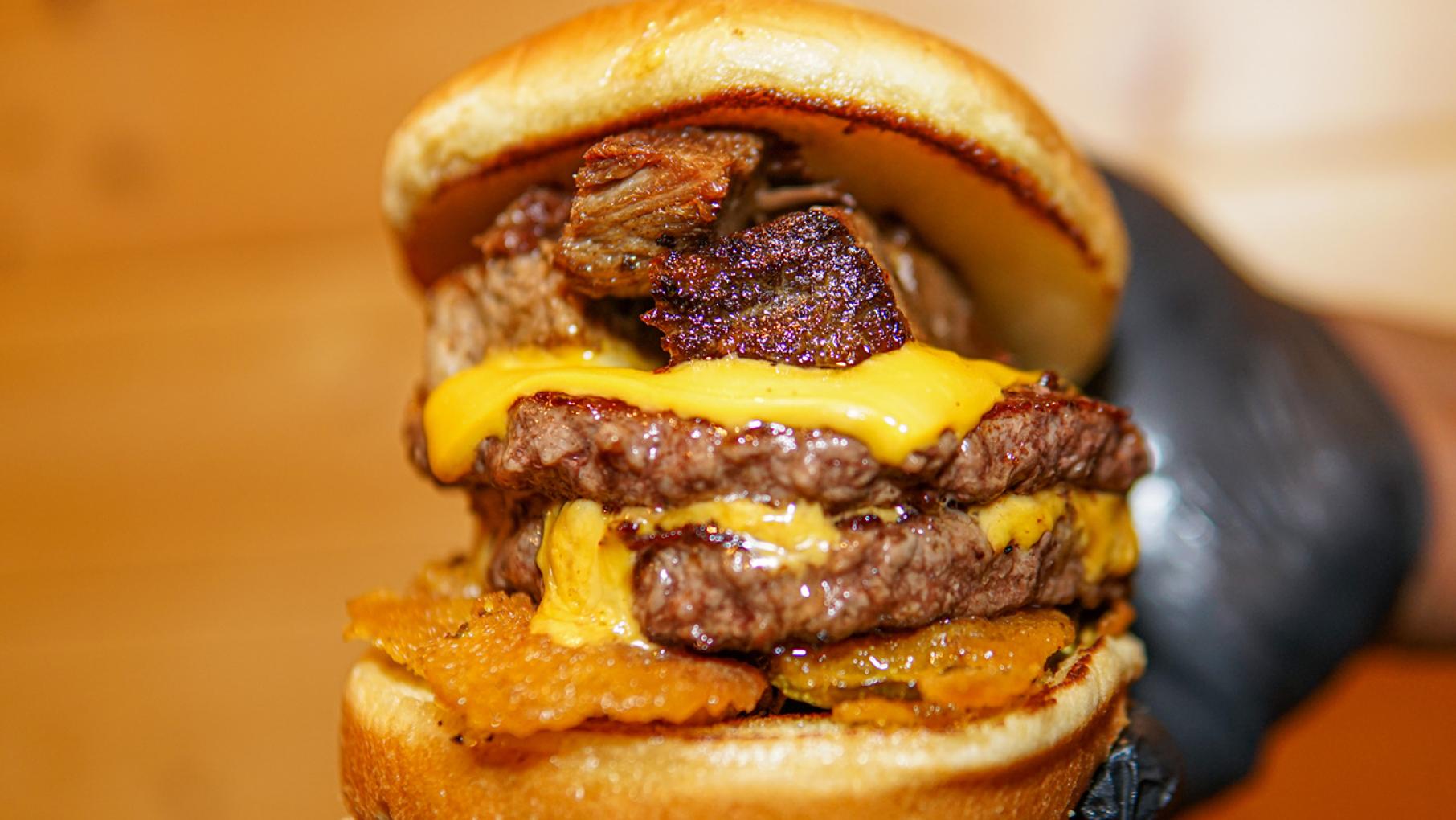 Brisket comes on a cheeseburger with fried pickles or on top of mac 'n' cheese at Bell Heir's BBQ. Photo: Provided A brisket cheeseburger from Bell Heir's BBQ