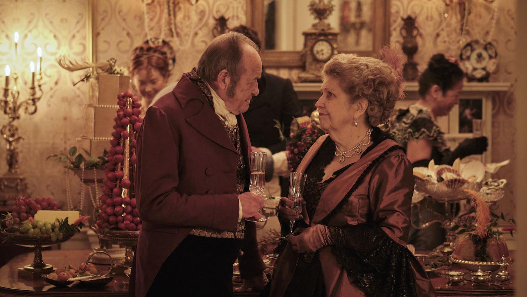 Lady Denham is enjoying her time with Rowleigh Pryce, but doesn't want to give up her title to marry him. Photo: Joss Barratt Rowleigh Pryce with Lady Denham at a party in Sanditon
