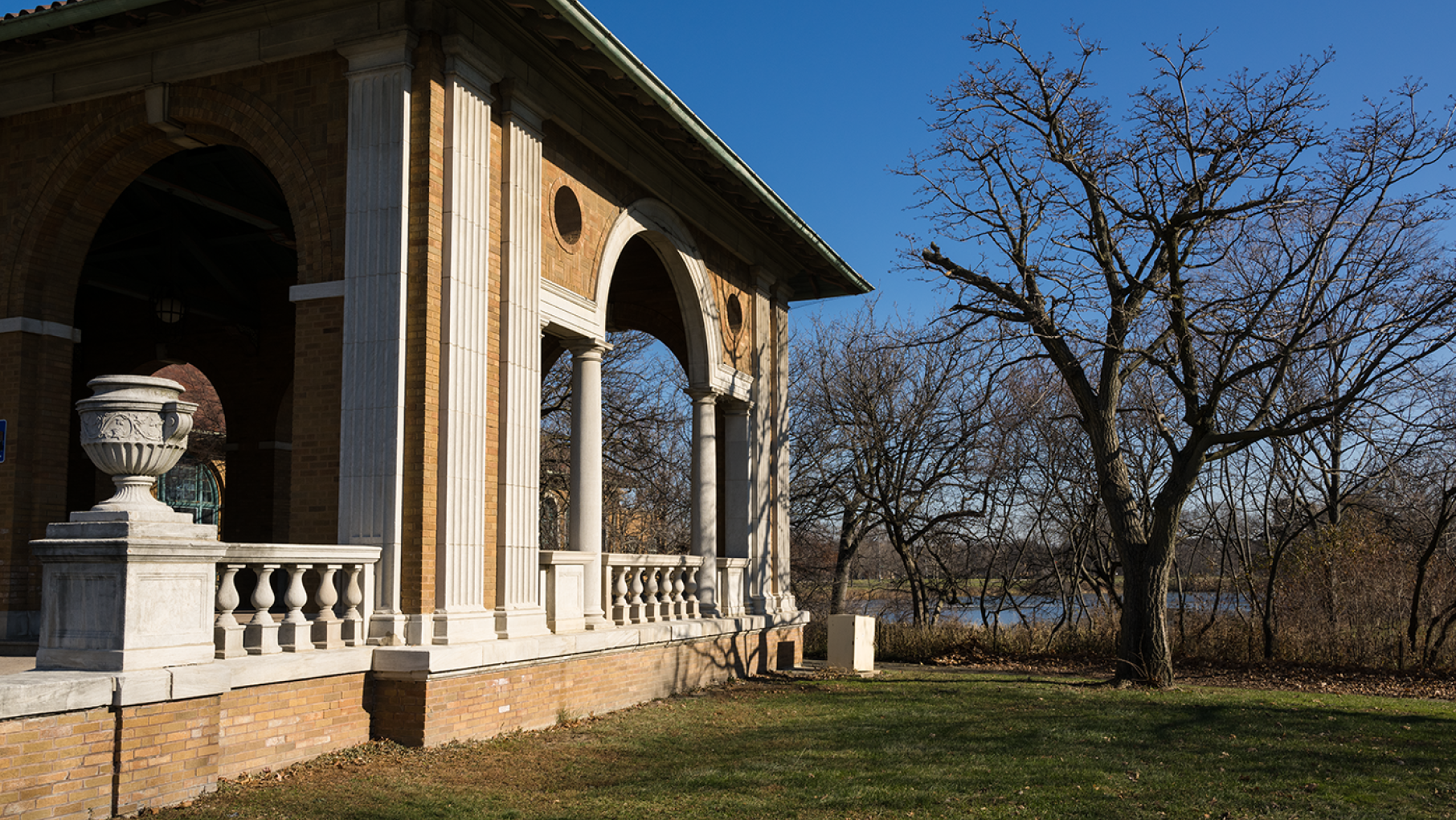 Columbus Park was the vision of Jens Jensen, an influential landscape architect responsible for several of Chicago's biggest parks. Photo: WTTW/Ken Carl The Columbus Park Refectory in Chicago by a bare tree