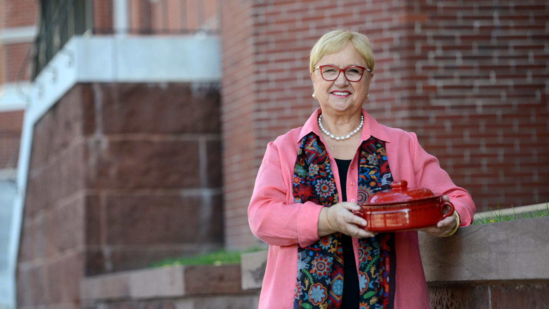 For a potluck dinner featuring chefs from across Washington, D.C. in her special 'Flavors That Define Us,' Lidia Bastianich brought a soup of escarole and white beans. Photo: Meredith Nierman / GBH & Tavola Productions Lidia Bastianich holding a pot with her escarole and white bean soup