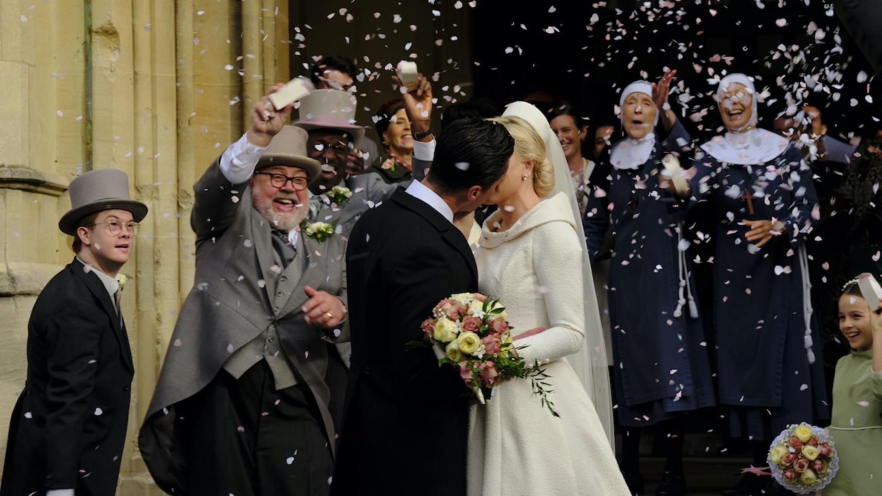 Matthew and Trixie kiss after their wedding as Reggie, Fred, the midwives, and others shower them with rice