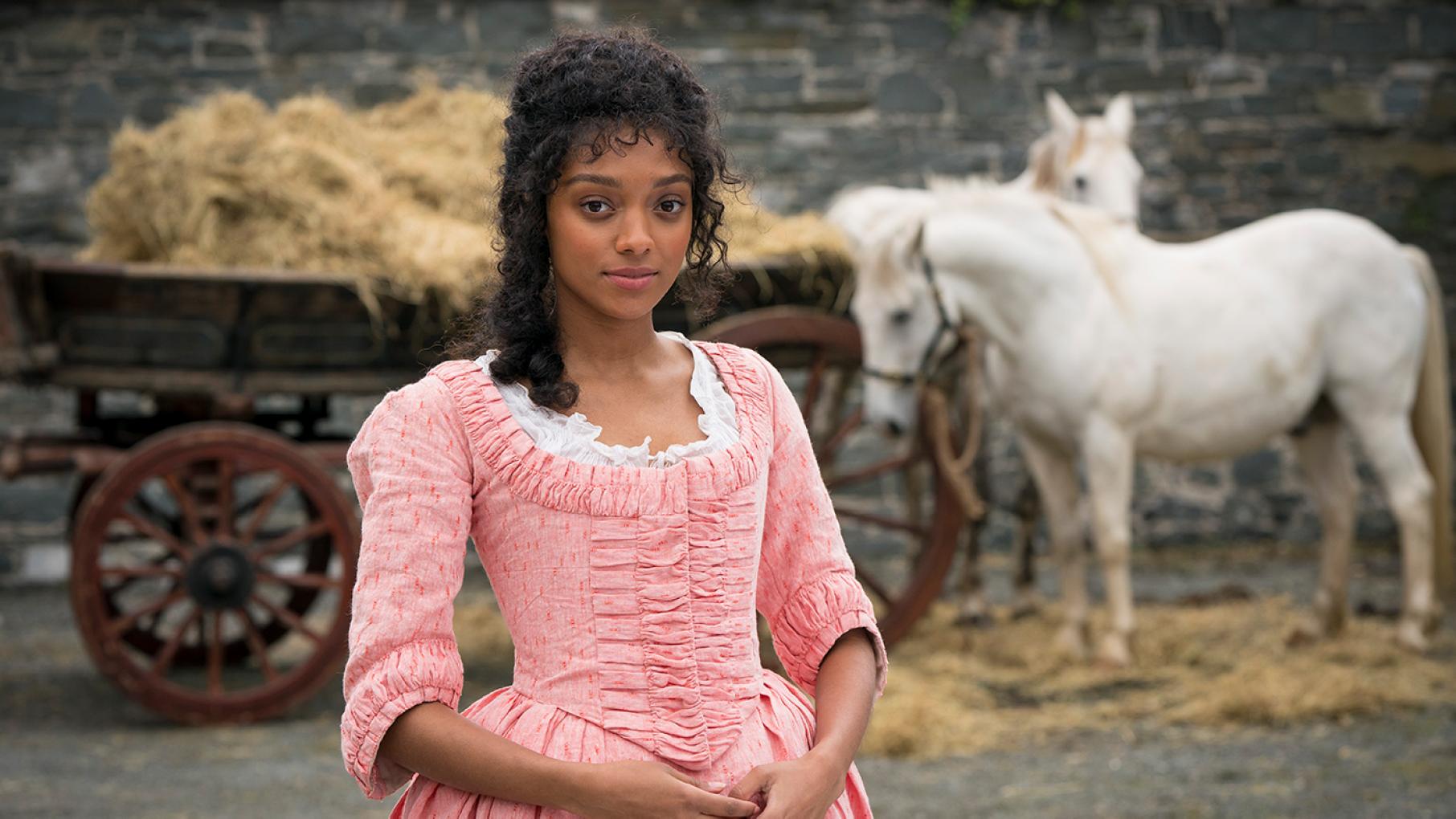 Sophia stands in front of horses in Tom Jones