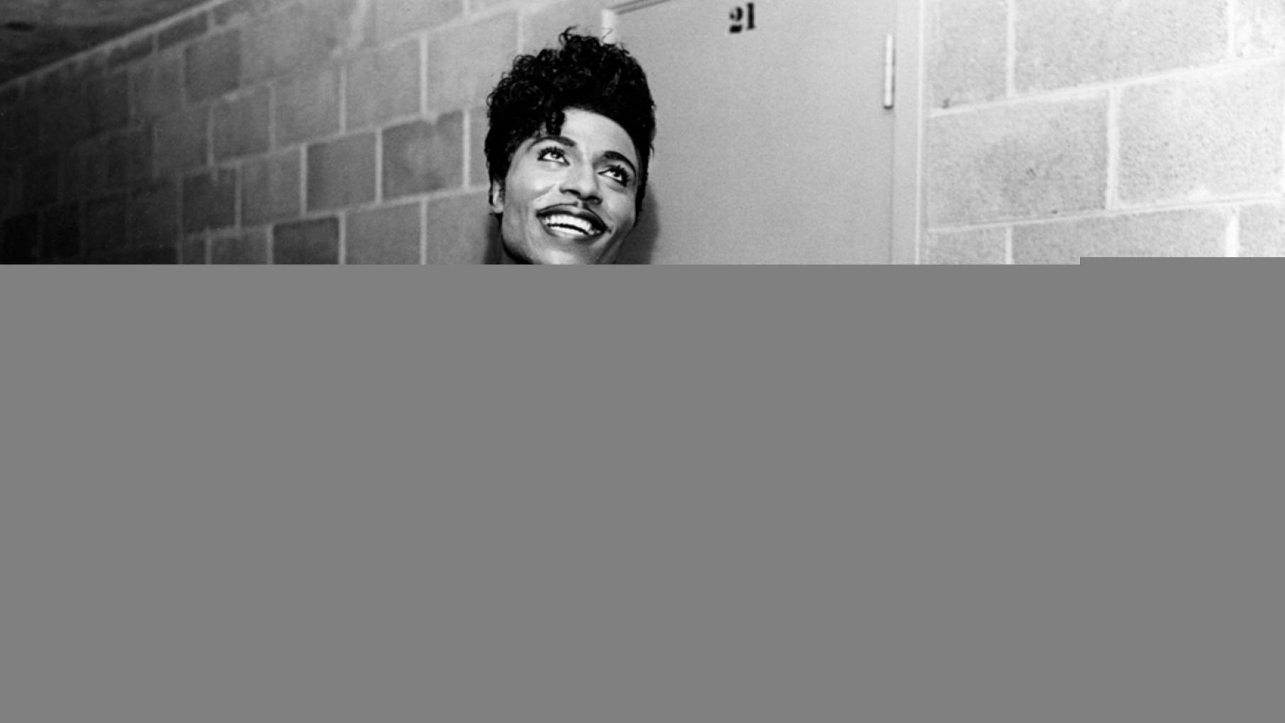 Little Richard in 1958, smiling with his arms up