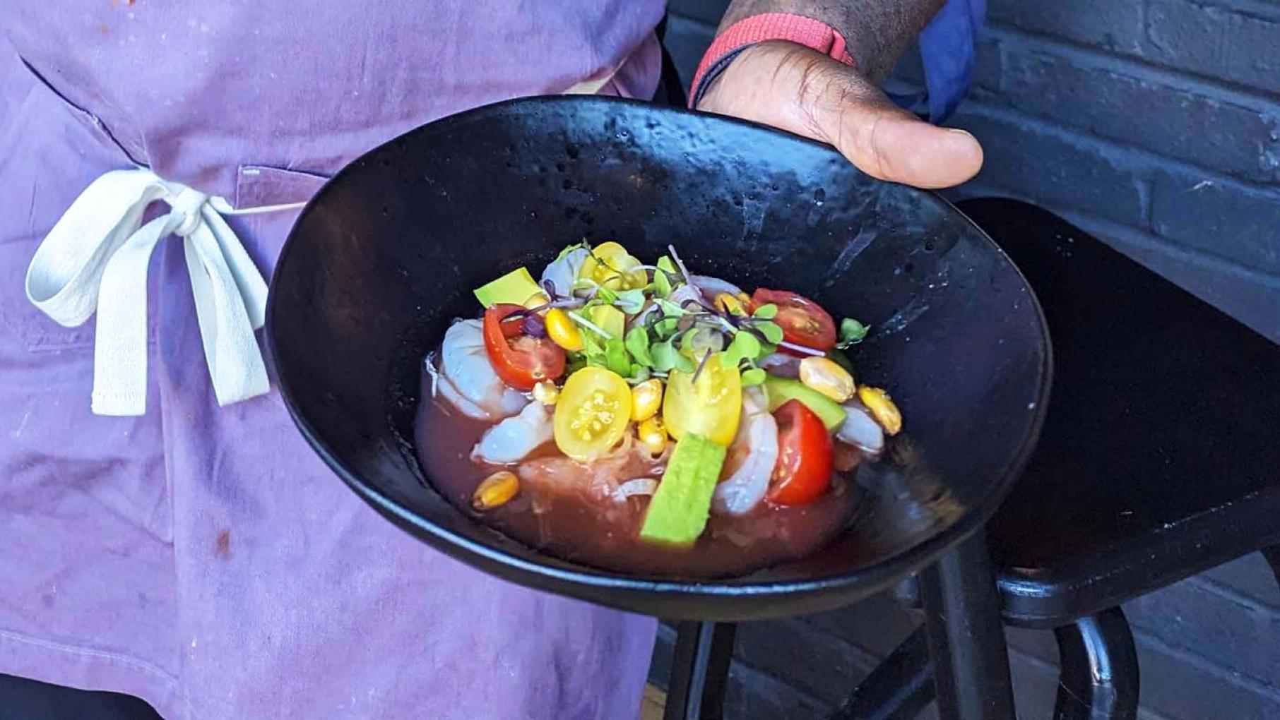 Lamar Moore presents his Tiger Shrimp Ceviche with Ají Limo Leche de Tigre. Image: Lisa Futterman Lamar Moore holding up his Tiger Shrimp Ceviche dish