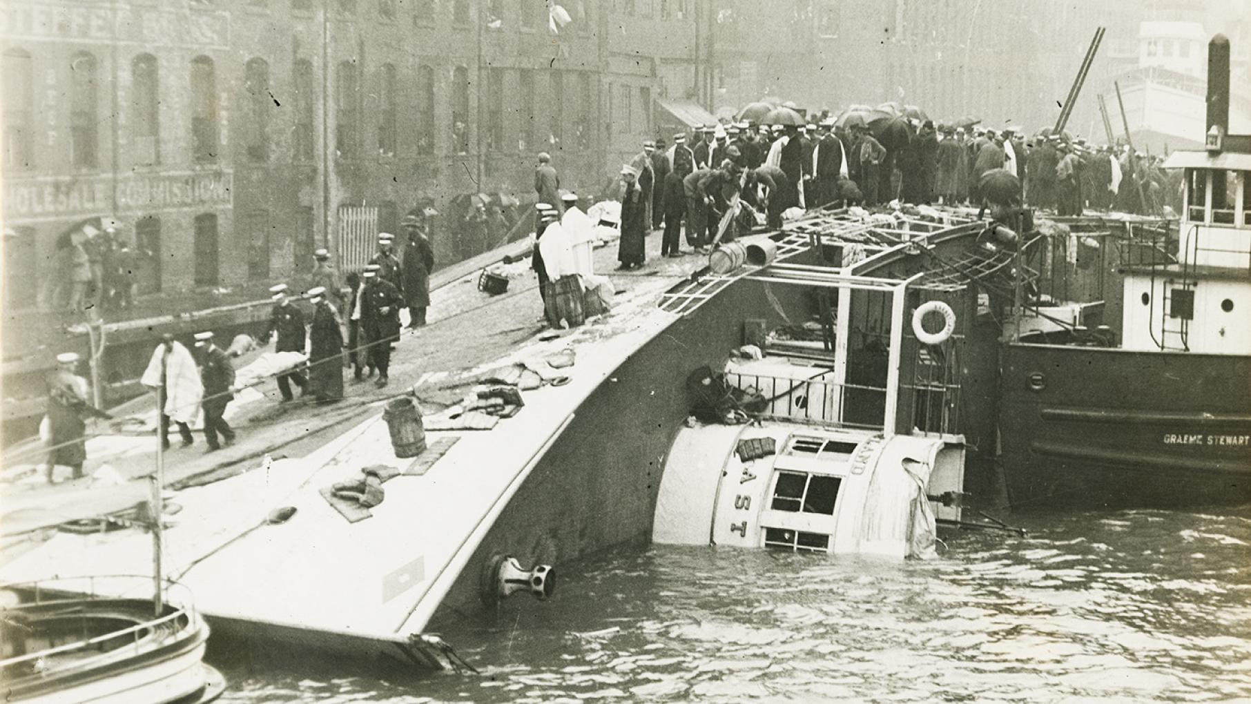 People stand atop the capsized Eastland steamer in the Chicago River on July 24, 1915. Image: Chicago History Museum, ICHi-040126; Jun Fujita, photographer People stand atop the capsized Eastland steamer in the Chicago River on July 24, 1915. Image: Chicago History Museum, ICHi-040126; Jun Fujita, photographer