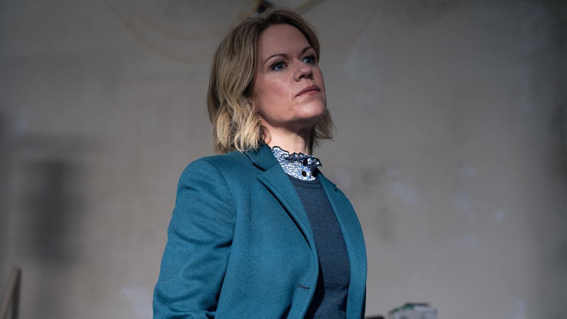 DCI Jess James undergoes an unexpected personal crisis on the very first day of her job at the head of DI Sunny Khan's team. Photo: Mainstreet Productions Jess James stands against a blank wall