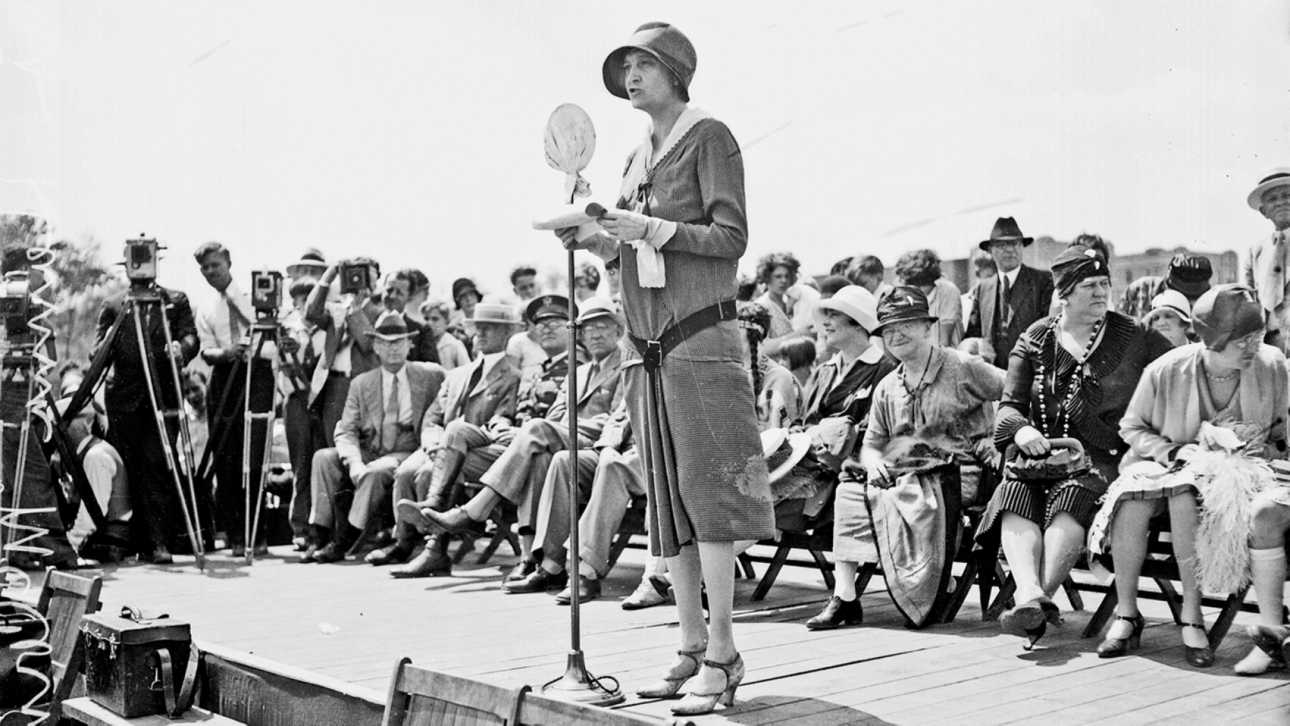 Ruth Hanna McCormick speaks in Chicago in 1929. Image: DN-0088613, Chicago Sun-Times/Chicago Daily News collection, Chicago History Museum Politician Ruth Hanna McCormick, U.S. Representative from Illinois at-large from 1929-1931, standing on an outdoor stage in Chicago, Illinois, 1929. Cameramen standing behind cameras mounted on tripods are visible in the background.