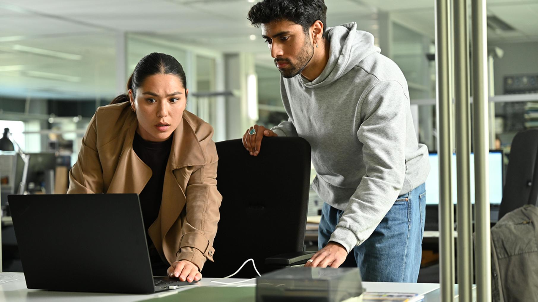 Citra Li and Eddie Suleman look at a laptop together