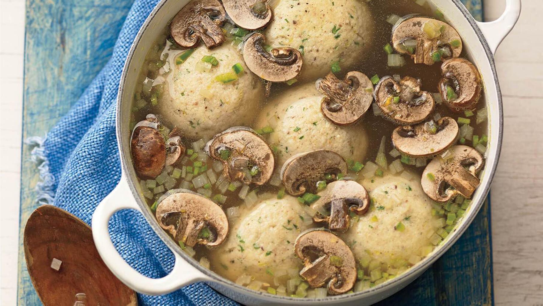 Pati Jinich's grandmother artfully incorporated jalapeños into matzo ball soup for a Mexican-Jewish crossover. Credit: Courtesy Pati Jinich A pot of mushroom jalapeno matzo ball soup seen from above, with a wooden spoon to the side