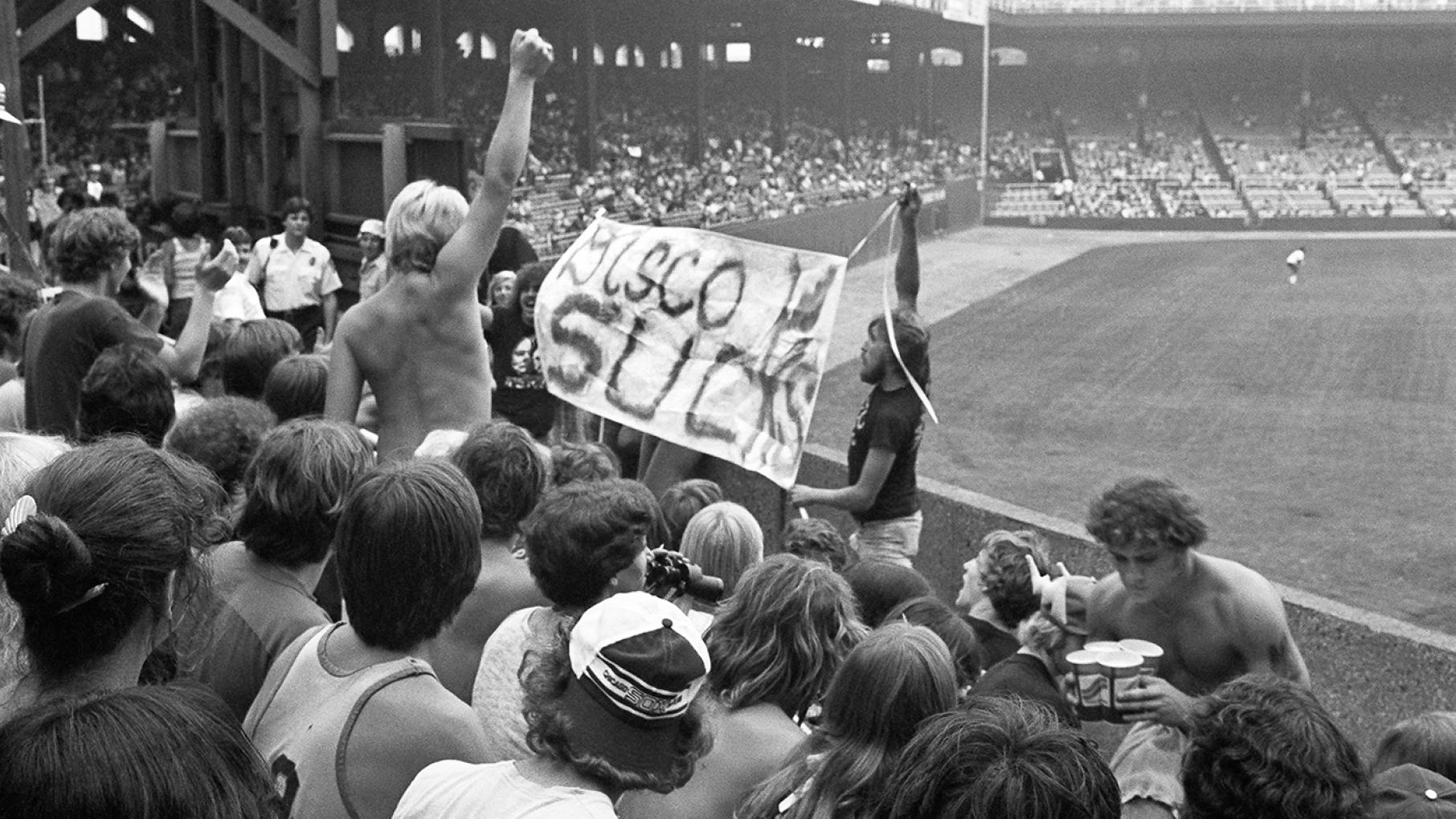 "Disco Demolition Night" at Comiskey Park on July 12, 1979 turned into an infamous riot. Credit: Diane Alexander White Fans hold a banner that reads "Disco Sucks" at Comiskey Park