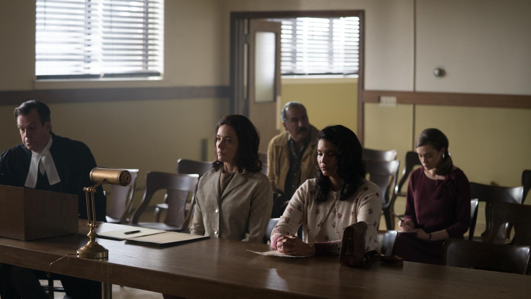 Patricia and others sit in a court room