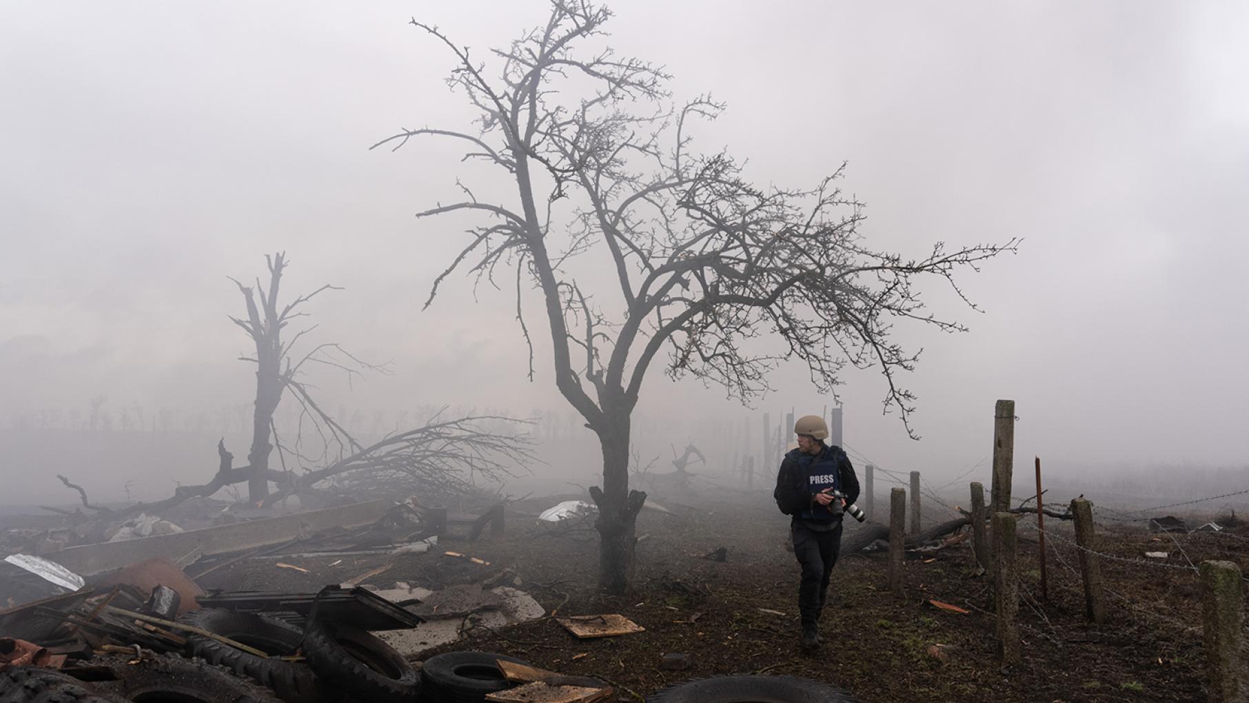 Photographer Evgeniy Maloletka picks his way through the aftermath of a Russian attack in Mariupol, Ukraine, Feb. 24, 2022. Still from FRONTLINE PBS and AP’s feature film “20 Days in Mariupol.” Credit: AP Photo/Mstyslav Chernov