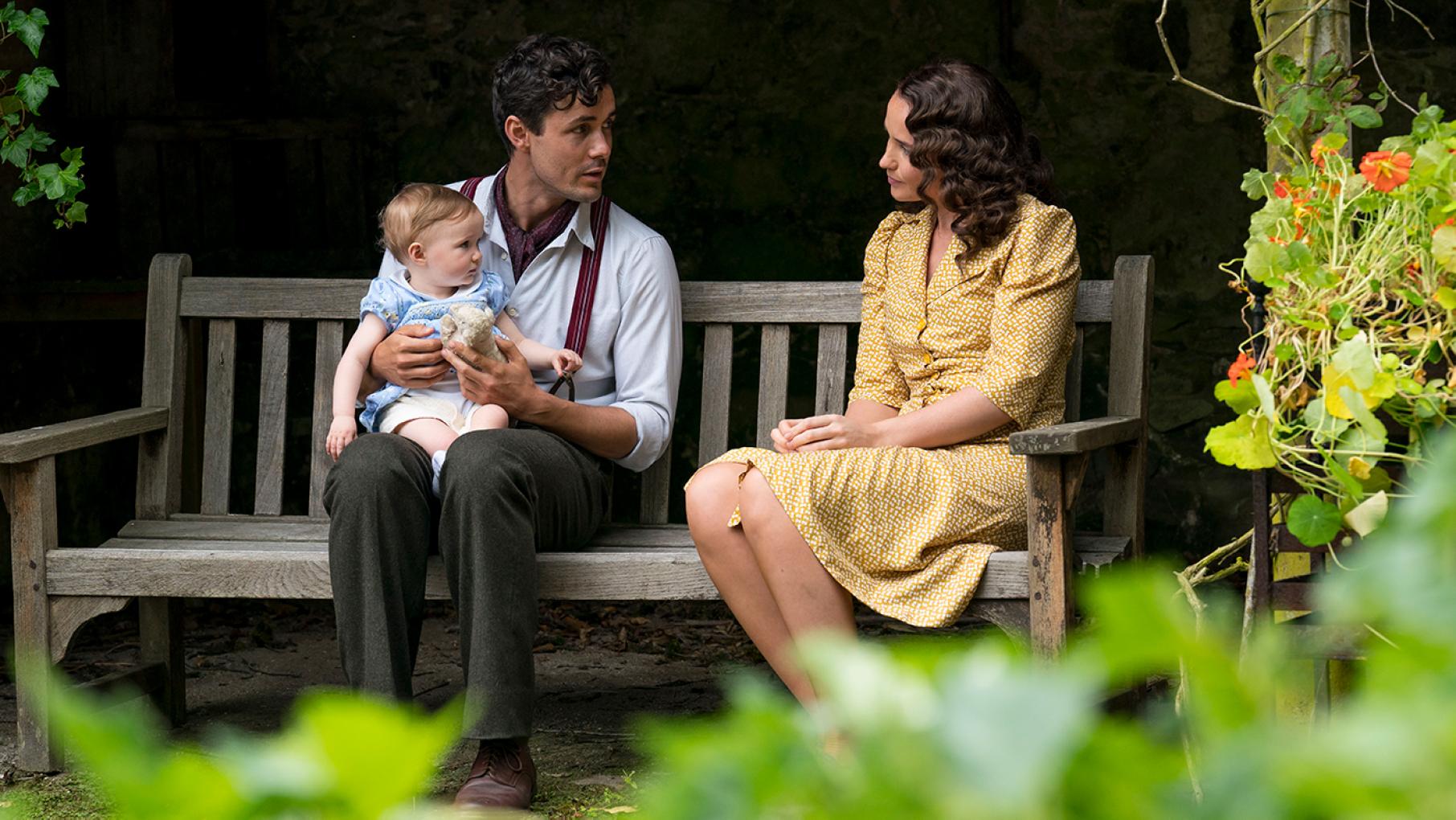 Harry and Lois both return to England. Credit: Steffan Hill for Mammoth Screen Harry sits with Vera on his lap on a bench next to Lois