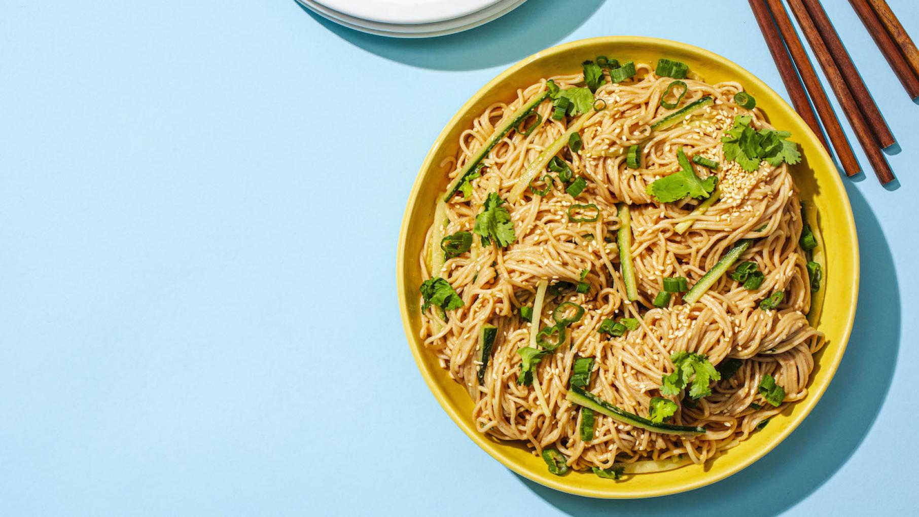 Sesame Noodles from 'America's Test Kitchen's new 'A Very Chinese Cookbook' topped our list. Credit: Kevin White for America's Test Kitchen A yellow bowl of sesame noodles on a blue background with chopsticks
