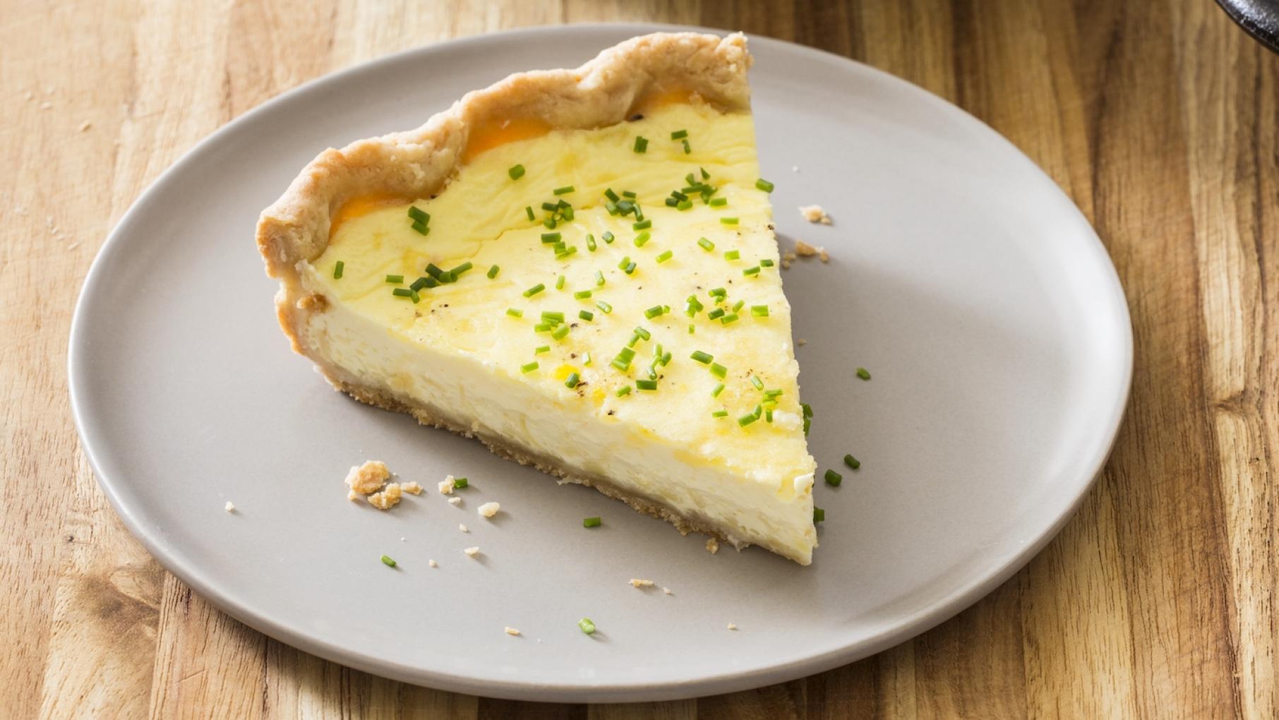 A slice of cheese quiche on a plate
