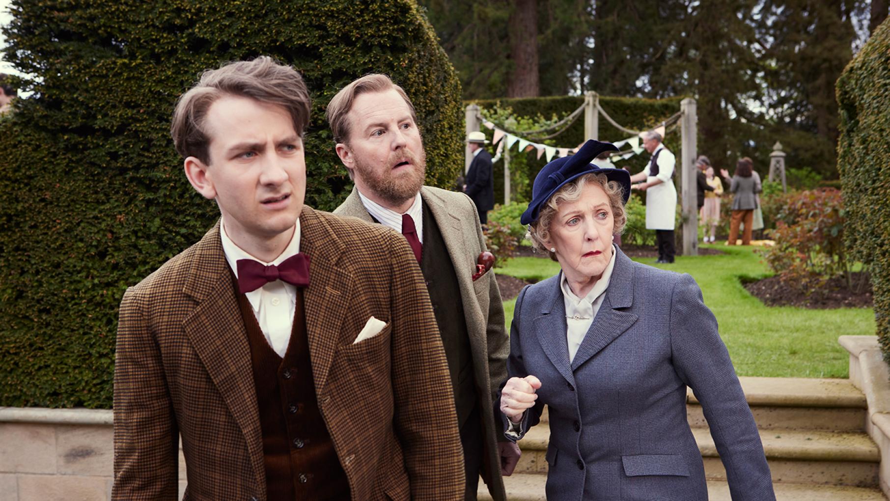 Richard Carmody is full of book knowledge but lacks real-world experience. Credit: Playground Entertainment and Masterpiece Richard, Siegfried, and Mrs. Pumphrey try to see something off screen
