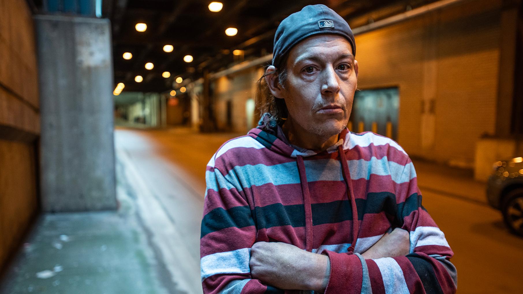 Dan is one of the subjects of WTTW's 'FIRSTHAND: Homeless.' Credit: Lloyd DeGrane for WTTW Dan stands in a backwards cap off a street in a tunnel
