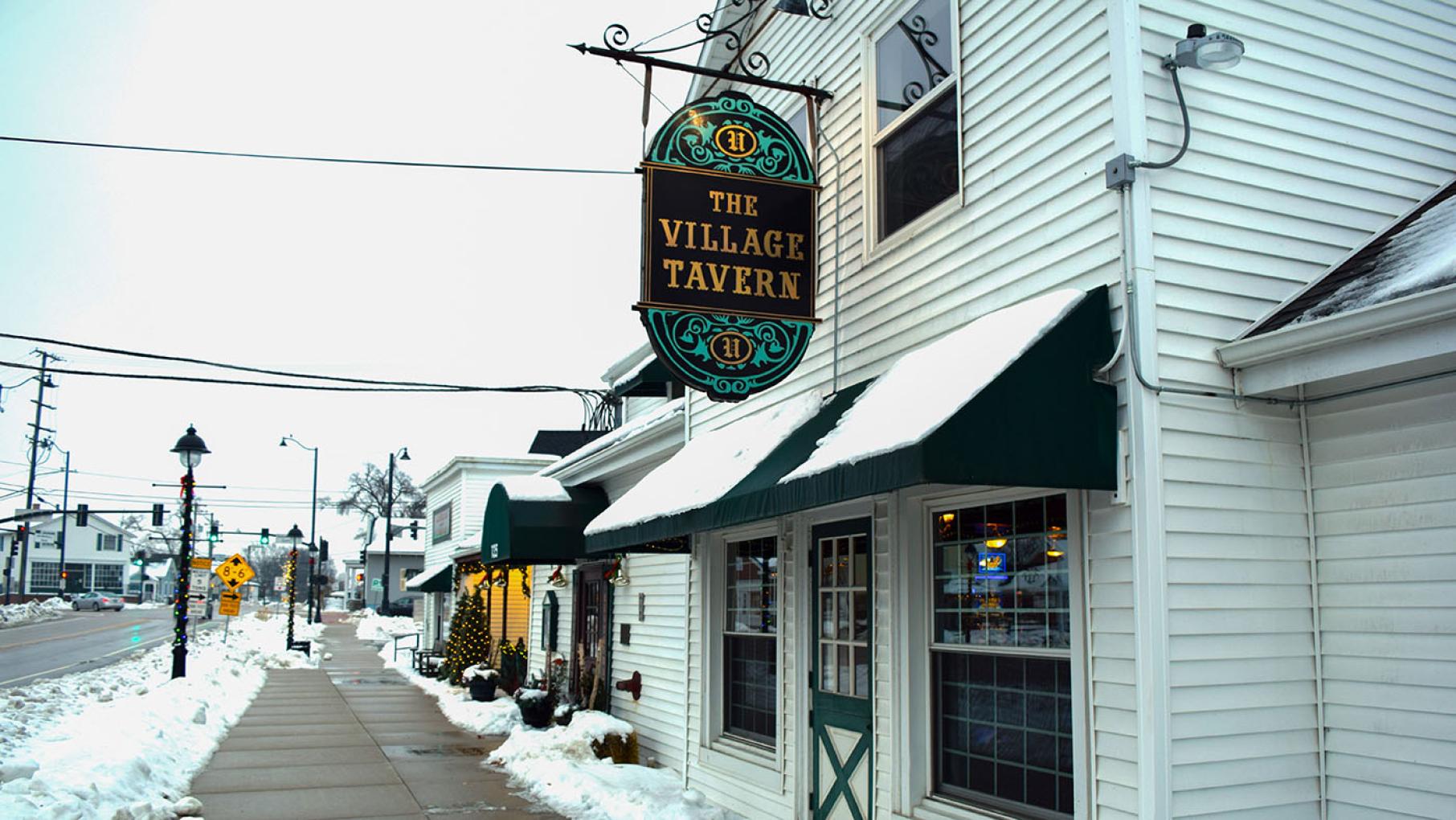 The Village Tavern in Long Grove, Illinois is the oldest restaurant in the state. Credit: Courtesy of The Village Tavern. An exterior view of The Village Tavern in Long Grove, pictured in winter with snow on the ground.