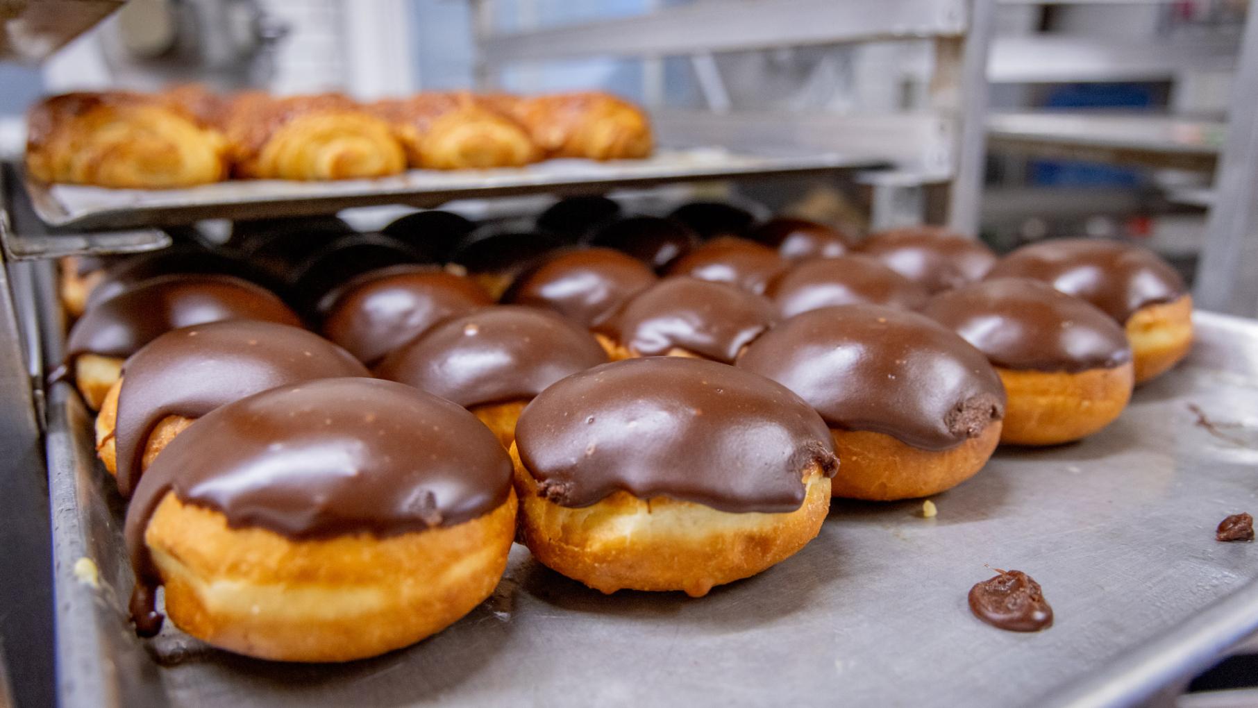 Custard pączki topped with chocolate at Delightful Pastries in Jefferson Park. Credit: Kathleen Hinkel for WTTW Custard pączki topped with chocolate