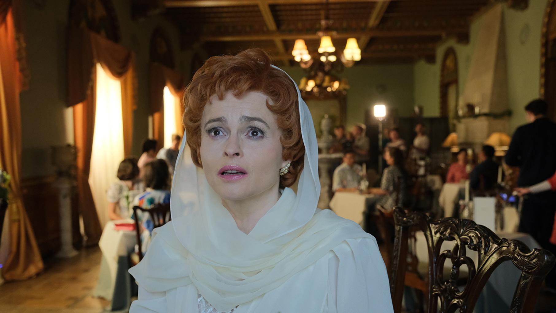 Nolly returns for a valedictory appearance on 'Crossroads' after her absence is felt. Credit: Quay Street Productions and Masterpiece Nolly sits in a restaurant with a white dress and white headscarf and looks into the distance with tears in her eyes