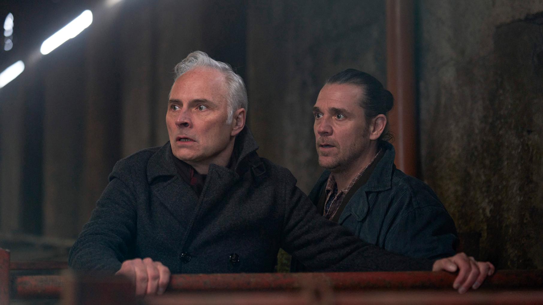 Jake and Max once again find themselves in danger. Credit: Expectation, Happy Tramp North, BBC, and Masterpiece Max and Jake look startled in a dark barn
