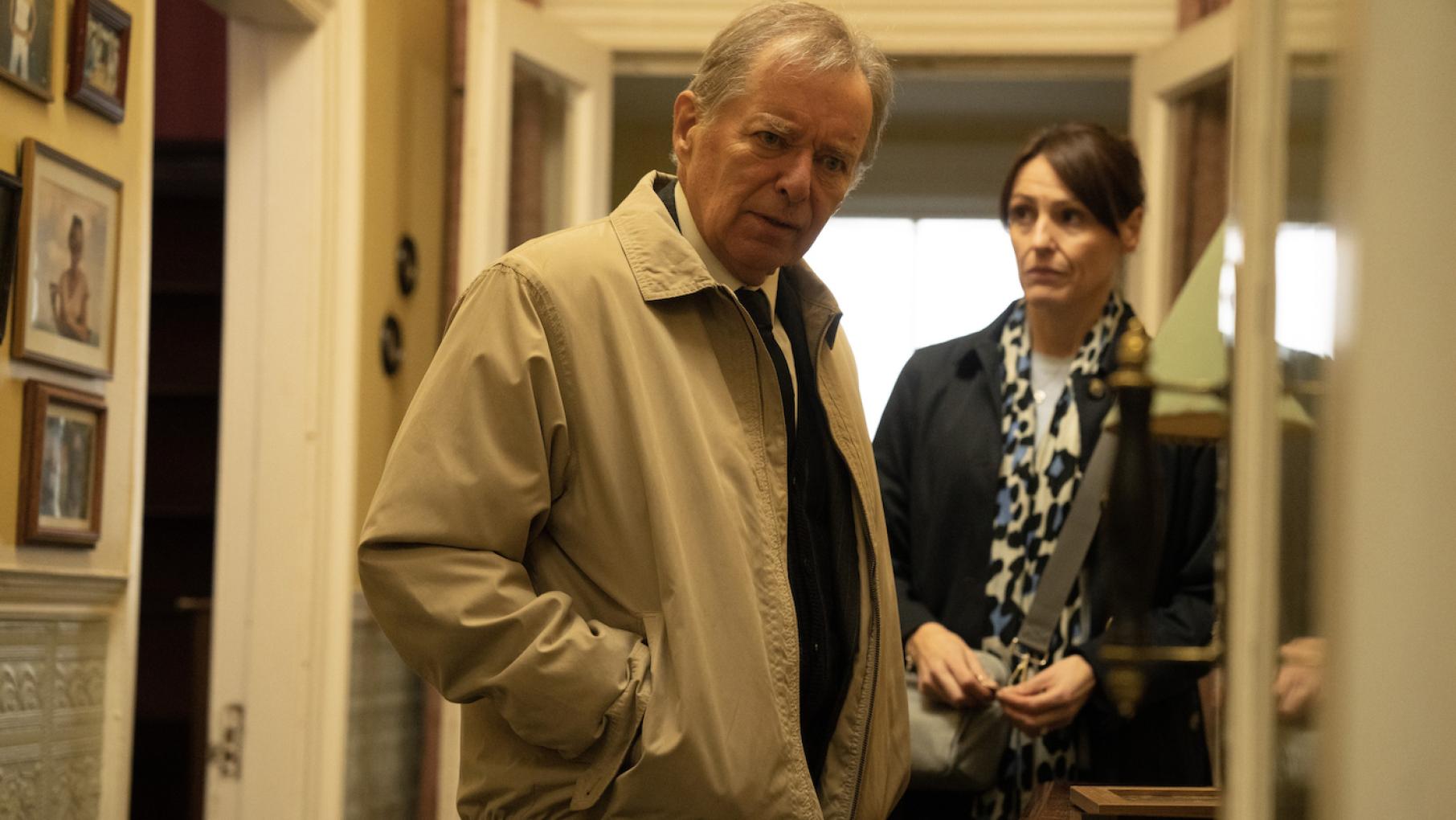 Richard looks upset in a hallway with Becca behind him