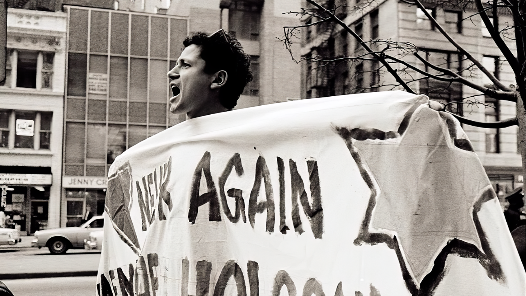 Danny Sotomayor was an AIDS activist and the first openly gay nationally syndicated political cartoonist. Image: Lisa Howe-Ebright Danny Sotomayor shouts while holding a banner in a black and white photo