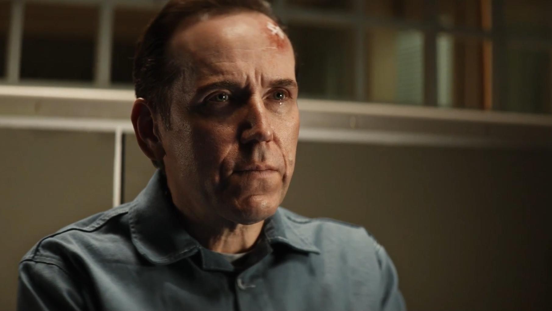 Professor T sits with a wound on his forehead
