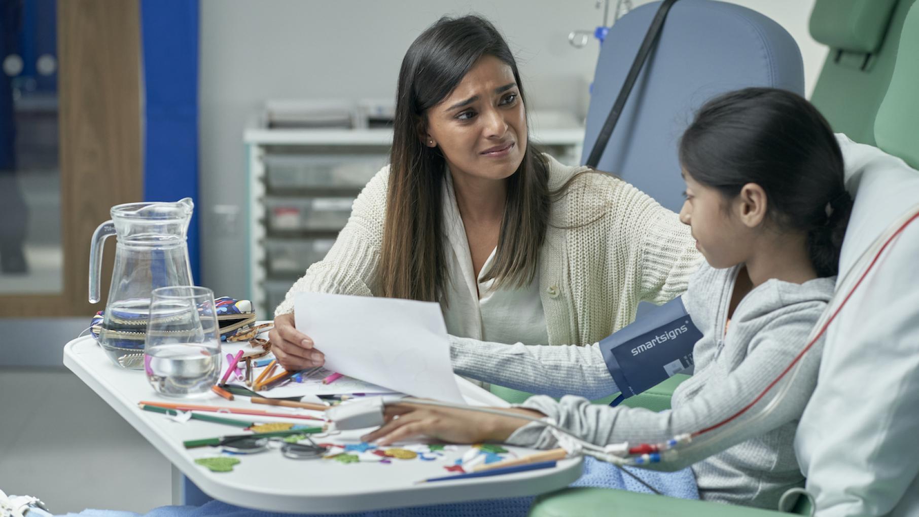 Amara's connection to the Mochanis, and Sajna's role in all of it, is finally discovered. Credit: Hat Trick Media Amara sits with a sad smile on her face with her daughter in the hospital