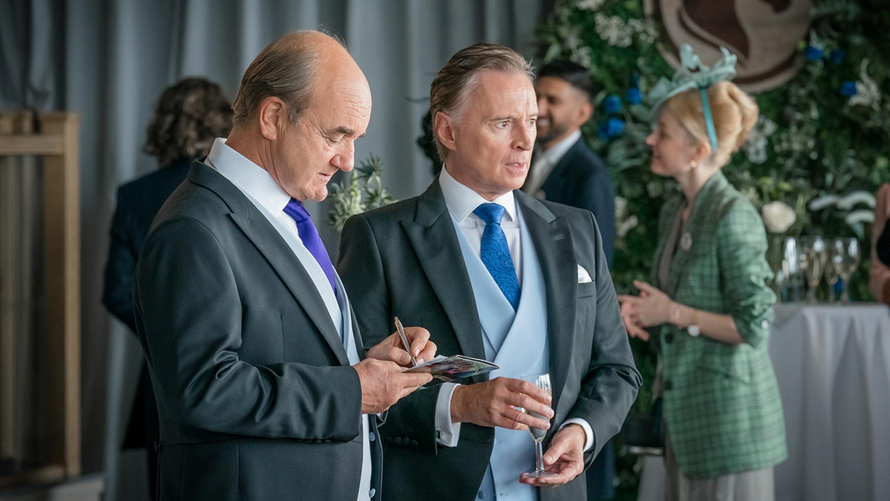 Robert is seeking investment from a Middle Eastern government even as protesters block one of his projects. Credit: Sky Studios Limited Archie and Robert stand in tuxedos