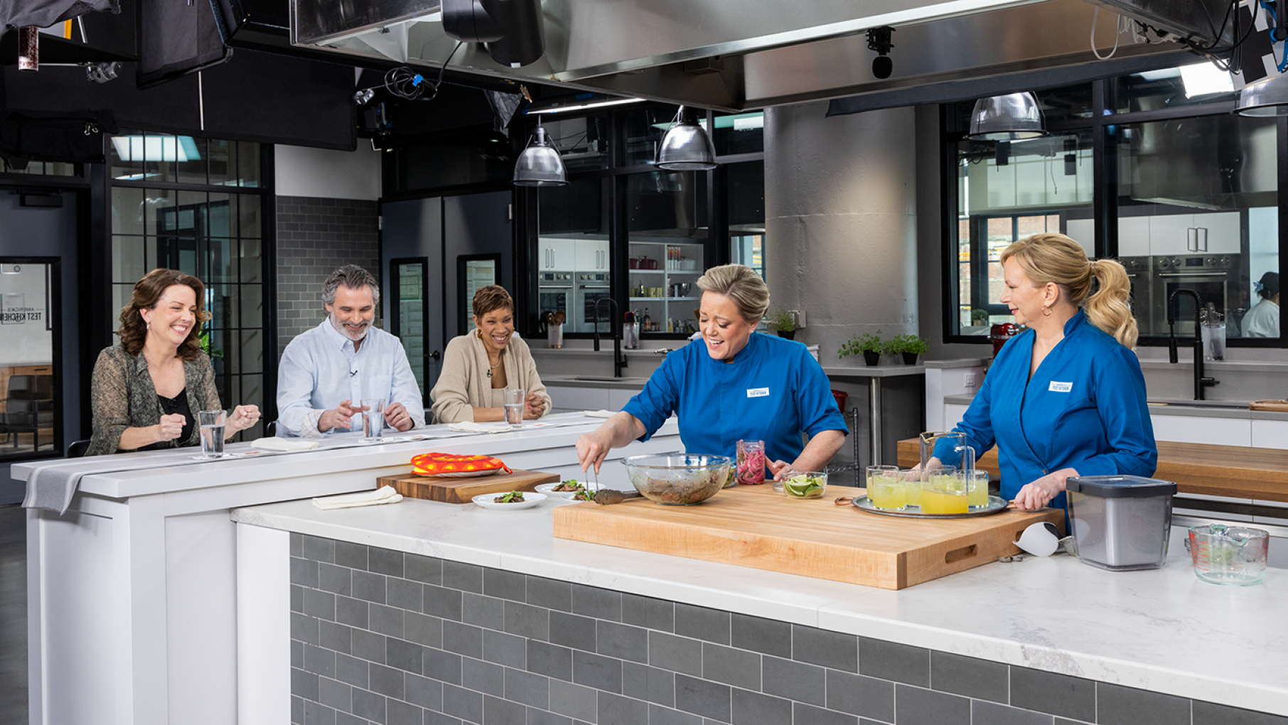 'America's Test Kitchen' celebrates 25 years with a new season and special. Credit: Daniel J. van Ackere Cooking on the set of America's Test Kitchen while three people watch