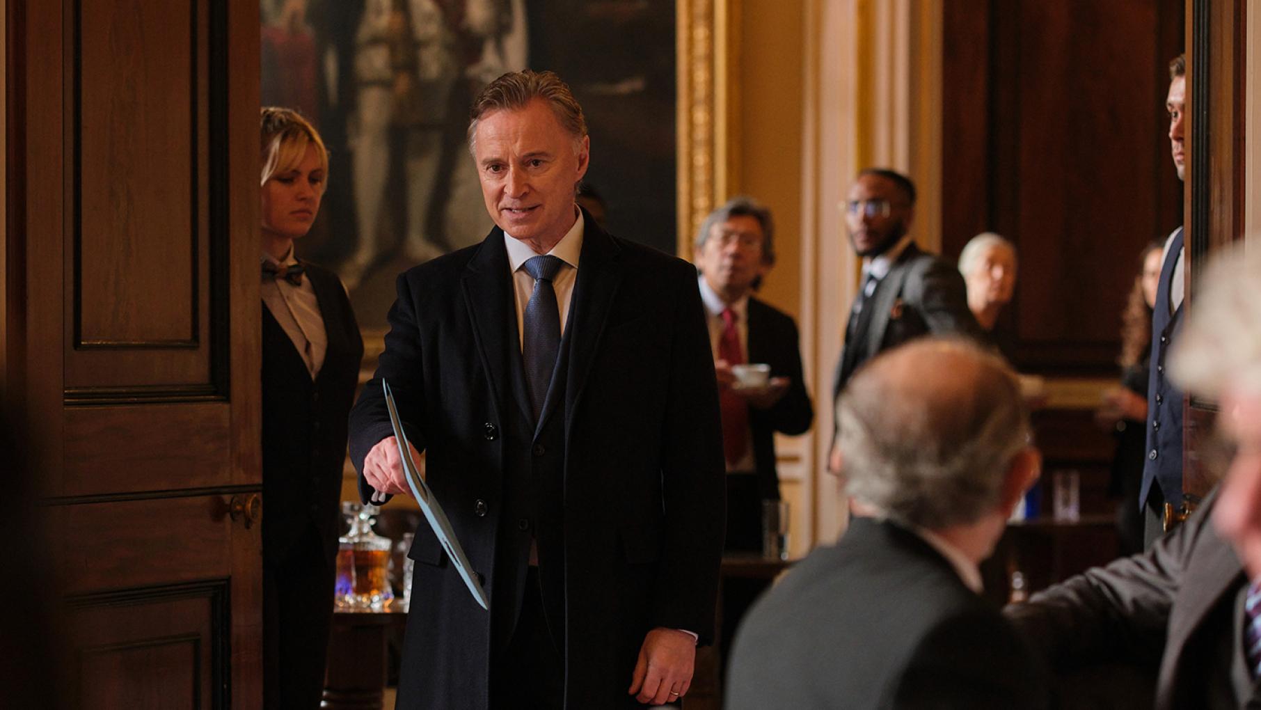 Credit: Sky Studios Limited Robert in an ornate room holds a folder