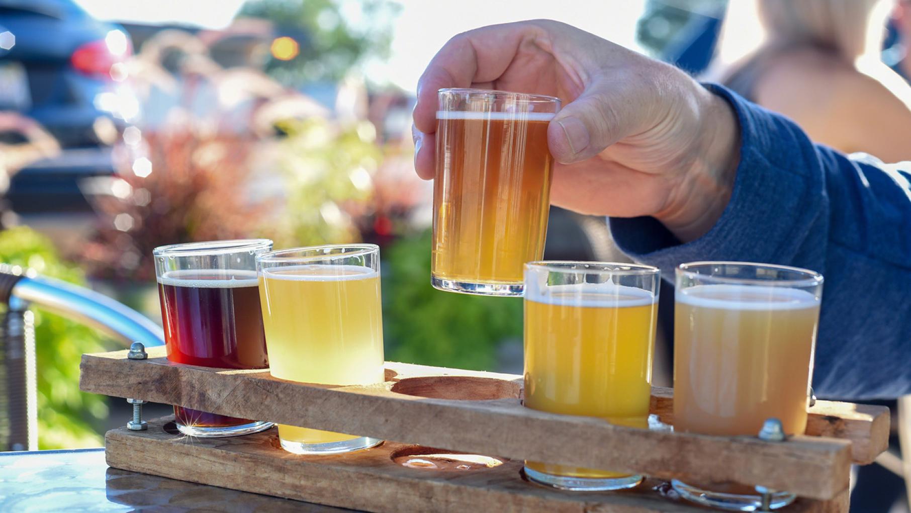 Credit: Kristen Prahl / iStock Beer samples in a wooden holder