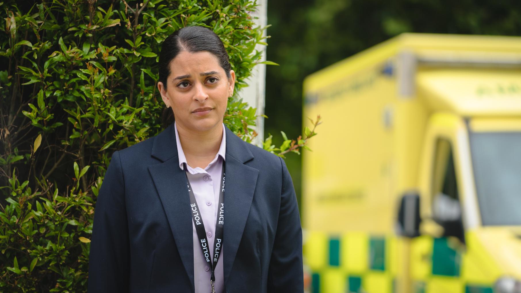 Tanika brings on Judith, Becks, and Suzie as advisers despite the misgivings of her colleagues. Credit: Masterpiece, Monumental Television, and UKTV Tanika stands near a yellow ambulance