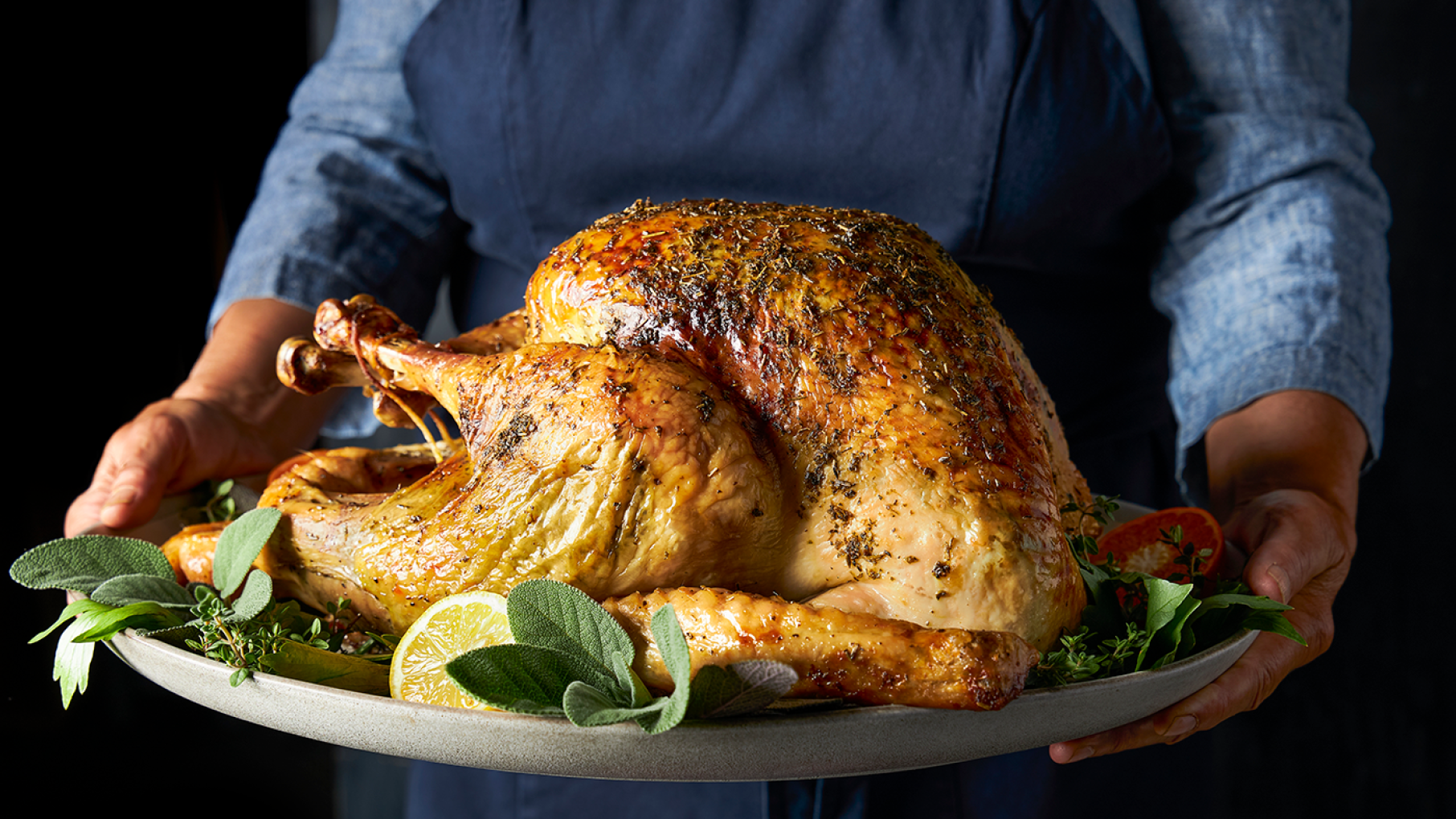 Credit: Elizabeth Fuller A person holds a turkey on a platter